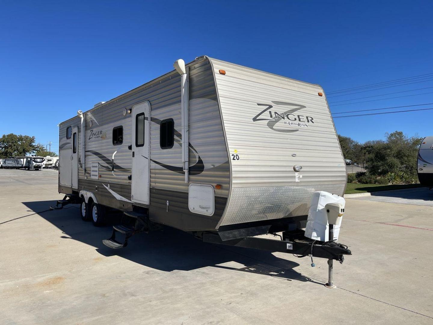 2013 WHITE ZINGER 31SB (4V0TC3129DJ) , Length: 35.5 ft. | Dry Weight: 7,875 lbs. | Gross Weight: 9,671 lbs. | Slides: 2 transmission, located at 4319 N Main Street, Cleburne, TX, 76033, (817) 221-0660, 32.435829, -97.384178 - This 2013 Zinger 31SB is a dual-axle steel wheel setup measuring 35.5 ft. long and 11.42 ft. tall. It has a dry weight of 7,875 lbs. and a GVWR of 9,671 lbs. It is designed with two doors, two slides, and one awning. The interior features two bedrooms, a bathroom, a kitchen, and a living area. The f - Photo#23