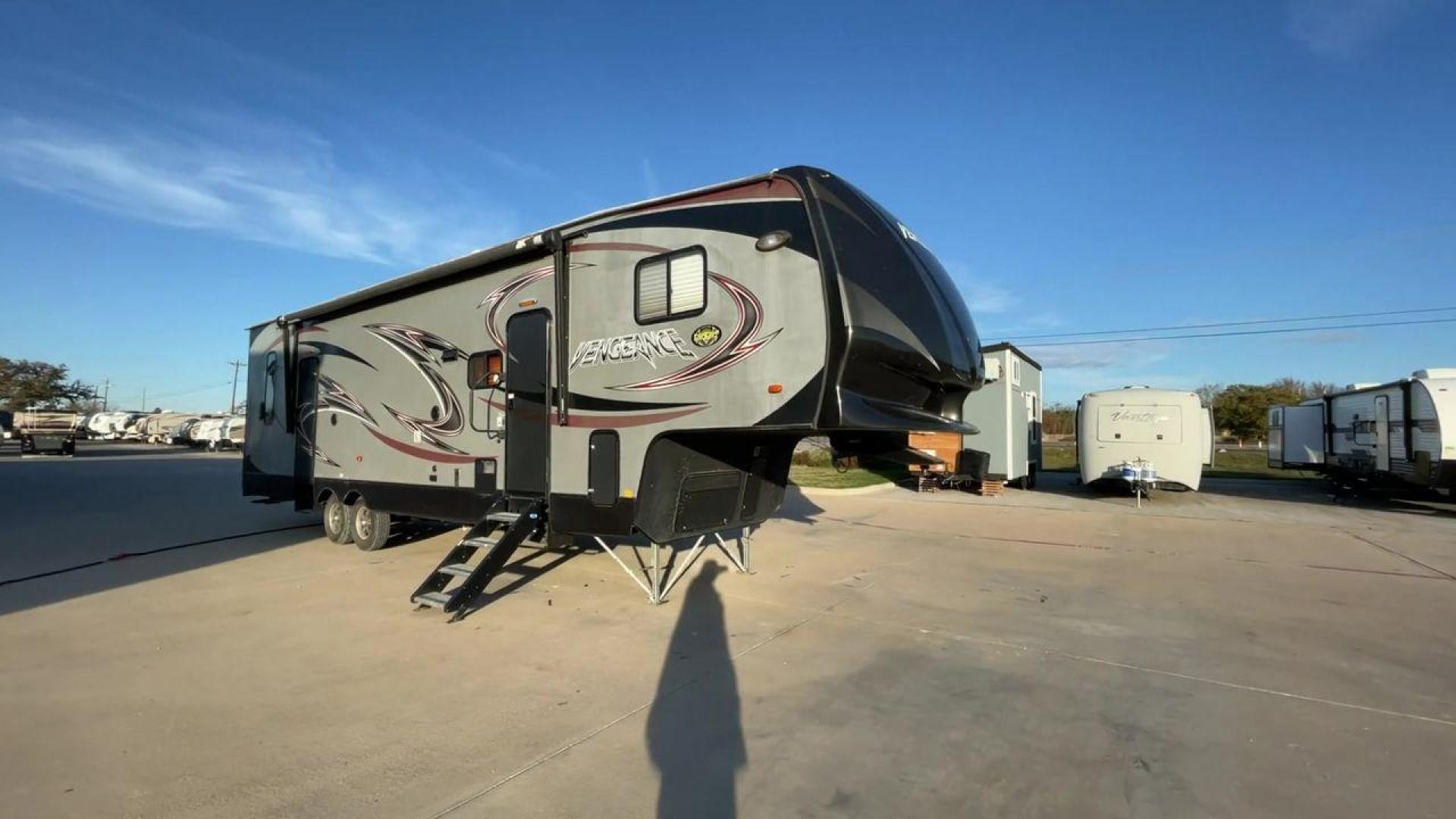 2014 WHITE FOREST RIVER VENGEANCE 312A (4X4FVGG22EY) , Length: 37.92 ft. | Dry Weight: 10,068 lbs. | Gross Weight: 14,508 lbs. | Slides: 1 transmission, located at 4319 N Main Street, Cleburne, TX, 76033, (817) 221-0660, 32.435829, -97.384178 - This 2014 Vengeance Toy Hauler has a dry weight of 10,068 lbs and a GVWR of 14,508 lbs with a hitch weight of 2,508 lbs. This unit also has automatic heating and cooling for optimal temperature control. The exterior of this toy hauler is a simple cream base with black and red accents. This model als - Photo#3