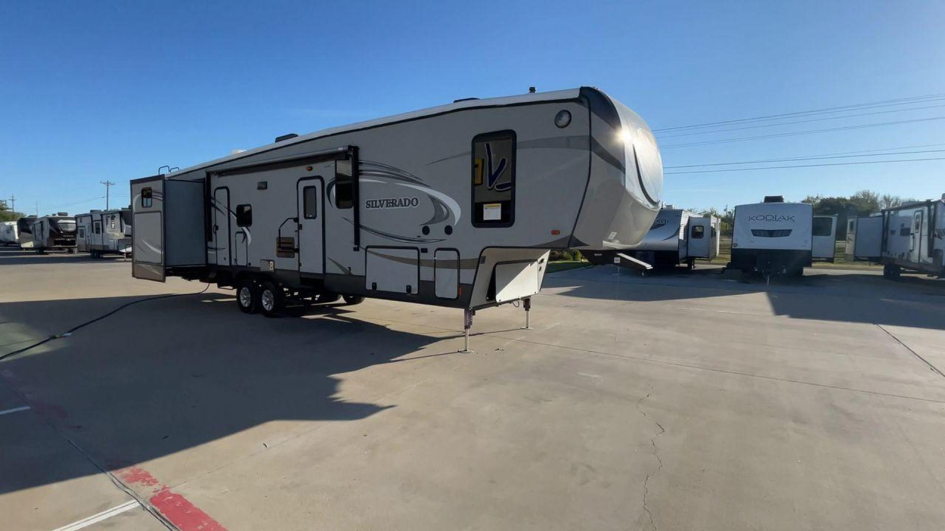 2014 HEARTLAND SILVERADO 37QB (5SFBG412XEE) , Length: 41.6 ft. | Dry Weight: 11,660 lbs. | Gross Weight: 15,000 lbs. | Slides: 4 transmission, located at 4319 N Main Street, Cleburne, TX, 76033, (817) 221-0660, 32.435829, -97.384178 - The 2014 Heartland Silverado 37QB fifth-wheel camper stands out with its spacious design and modern aesthetic. Measuring 41.6 feet in length, this unit has a dry weight of 11,660 lbs and a gross weight of 15,000 lbs, making it a substantial yet manageable choice for extended trips or full-time livin - Photo#3