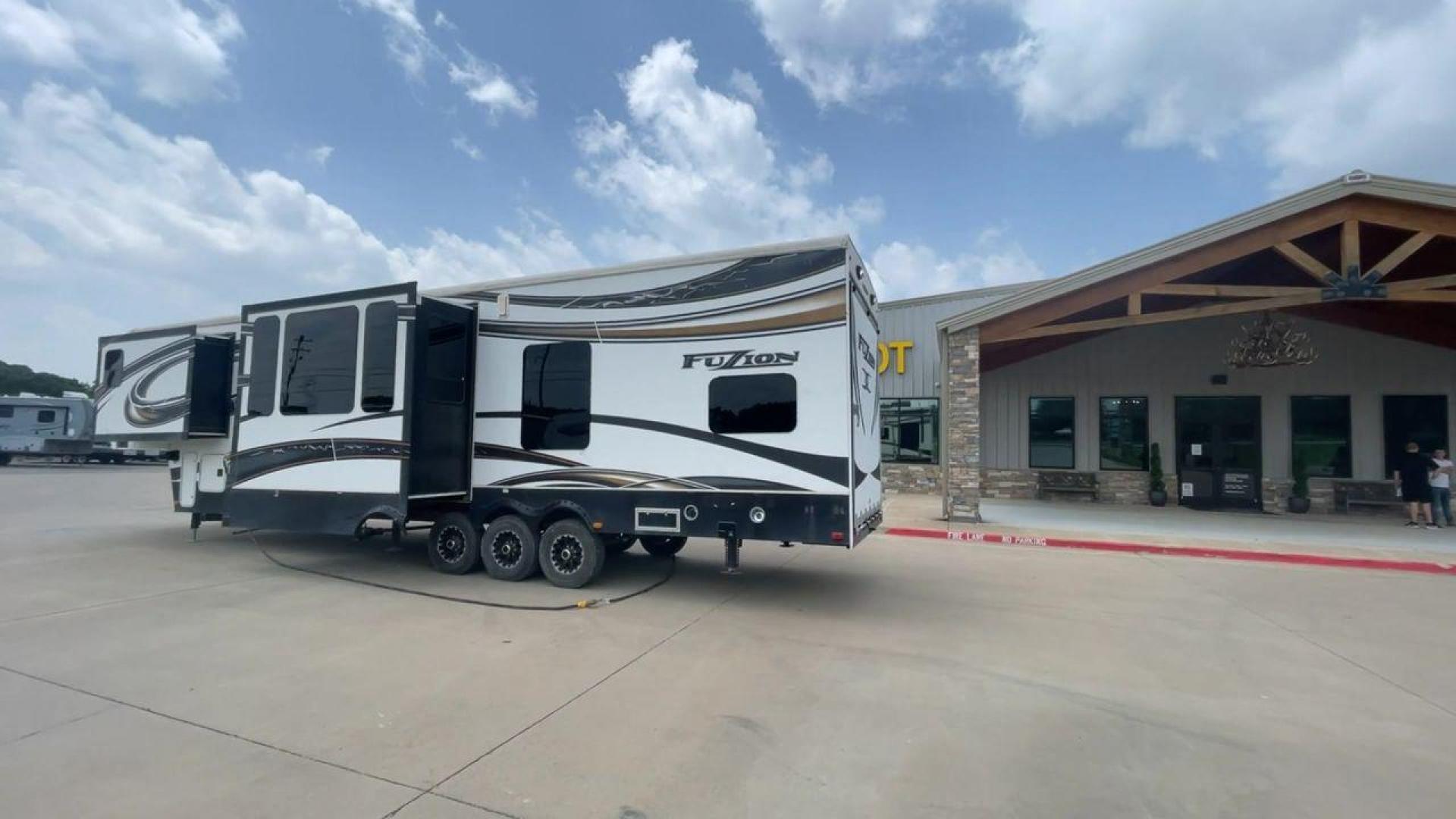 2014 WHITE KEYSTONE FUZION M-399 (4YDF39939EF) , Length: 41 ft. | Dry Weight: 14,100 lbs. | Gross Weight: 18,000 lbs. | Slides: 3 transmission, located at 4319 N Main Street, Cleburne, TX, 76033, (817) 221-0660, 32.435829, -97.384178 - The 2014 Keystone Fuzion M-399 offers exceptional value for its price. With its white exterior color, this RV stands out on the road and is sure to turn heads wherever you go. Measuring 41 ft. in length, this toy hauler provides ample space for you and your loved ones to relax and enjoy your travels - Photo#7