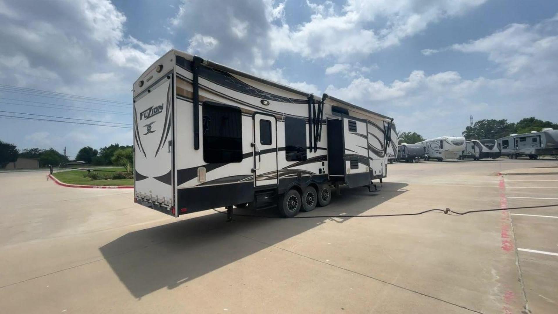 2014 WHITE KEYSTONE FUZION M-399 (4YDF39939EF) , Length: 41 ft. | Dry Weight: 14,100 lbs. | Gross Weight: 18,000 lbs. | Slides: 3 transmission, located at 4319 N Main Street, Cleburne, TX, 76033, (817) 221-0660, 32.435829, -97.384178 - The 2014 Keystone Fuzion M-399 offers exceptional value for its price. With its white exterior color, this RV stands out on the road and is sure to turn heads wherever you go. Measuring 41 ft. in length, this toy hauler provides ample space for you and your loved ones to relax and enjoy your travels - Photo#1