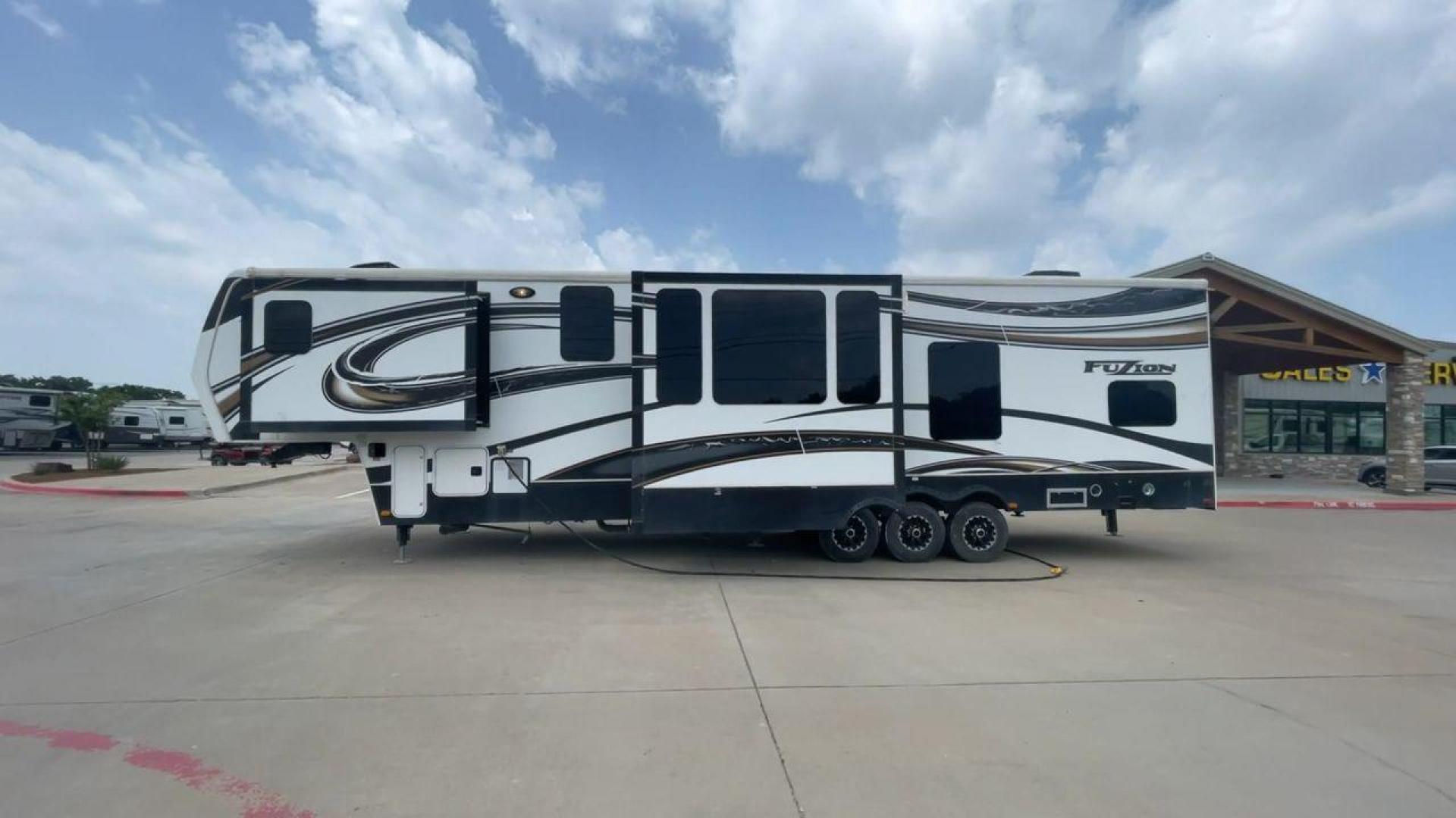 2014 WHITE KEYSTONE FUZION M-399 (4YDF39939EF) , Length: 41 ft. | Dry Weight: 14,100 lbs. | Gross Weight: 18,000 lbs. | Slides: 3 transmission, located at 4319 N Main Street, Cleburne, TX, 76033, (817) 221-0660, 32.435829, -97.384178 - The 2014 Keystone Fuzion M-399 offers exceptional value for its price. With its white exterior color, this RV stands out on the road and is sure to turn heads wherever you go. Measuring 41 ft. in length, this toy hauler provides ample space for you and your loved ones to relax and enjoy your travels - Photo#6