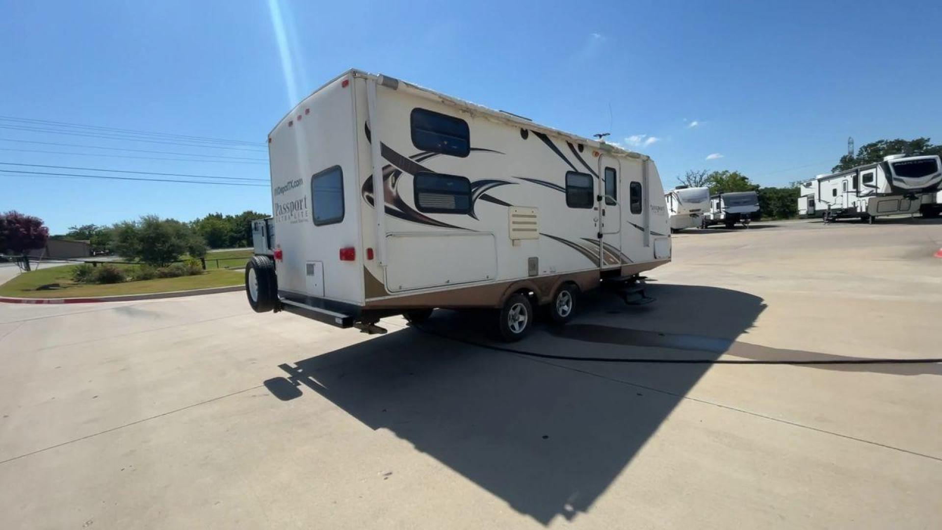 2014 WHITE KEYSTONE PASSPORT 2400BH (4YDT24029ET) , Length: 27.83 ft. | Dry Weight: 4,730 lbs. | Gross Weight: 6,800 lbs. | Slides: 1 transmission, located at 4319 N Main Street, Cleburne, TX, 76033, (817) 221-0660, 32.435829, -97.384178 - The 2014 Keystone Passport 2400BH is a dual-axle steel wheel set-up that measures 27.83 ft. in length. It has a dry weight of 4,730 lbs. and a GVWR of 6,800 lbs. It also has a payload capacity of 2,070 lbs. and a hitch weight of 515 lbs. Its exterior is a base color of white with black and brown acc - Photo#1