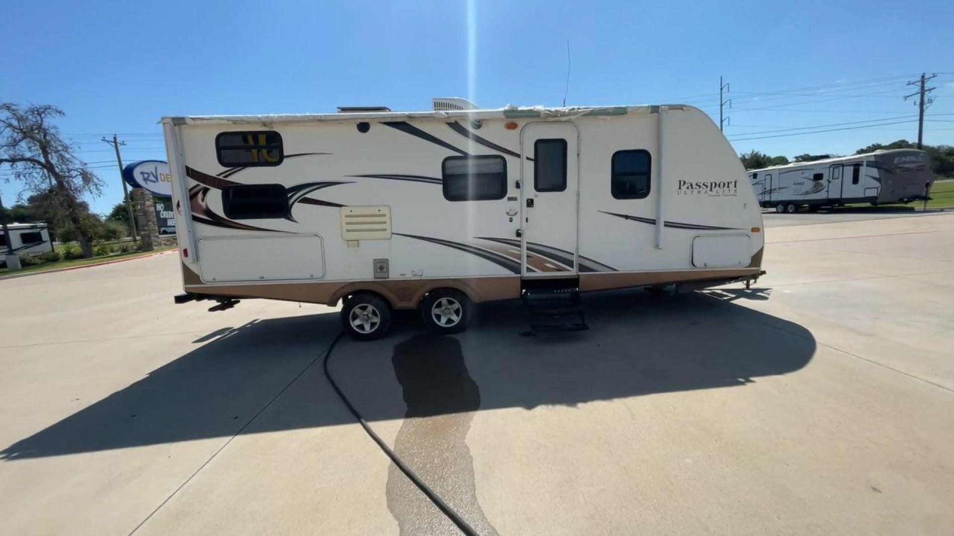 2014 WHITE KEYSTONE PASSPORT 2400BH (4YDT24029ET) , Length: 27.83 ft. | Dry Weight: 4,730 lbs. | Gross Weight: 6,800 lbs. | Slides: 1 transmission, located at 4319 N Main Street, Cleburne, TX, 76033, (817) 221-0660, 32.435829, -97.384178 - The 2014 Keystone Passport 2400BH is a dual-axle steel wheel set-up that measures 27.83 ft. in length. It has a dry weight of 4,730 lbs. and a GVWR of 6,800 lbs. It also has a payload capacity of 2,070 lbs. and a hitch weight of 515 lbs. Its exterior is a base color of white with black and brown acc - Photo#2