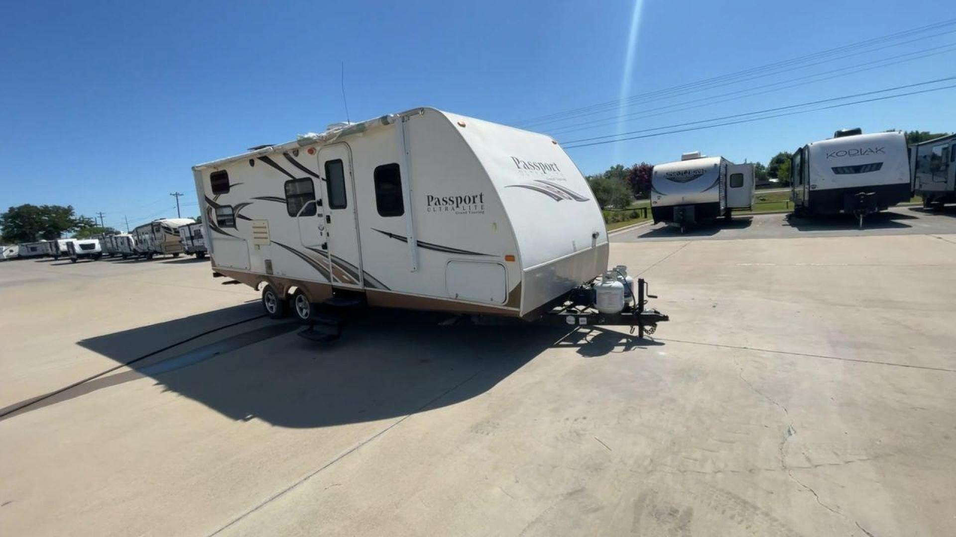 2014 WHITE KEYSTONE PASSPORT 2400BH (4YDT24029ET) , Length: 27.83 ft. | Dry Weight: 4,730 lbs. | Gross Weight: 6,800 lbs. | Slides: 1 transmission, located at 4319 N Main Street, Cleburne, TX, 76033, (817) 221-0660, 32.435829, -97.384178 - The 2014 Keystone Passport 2400BH is a dual-axle steel wheel set-up that measures 27.83 ft. in length. It has a dry weight of 4,730 lbs. and a GVWR of 6,800 lbs. It also has a payload capacity of 2,070 lbs. and a hitch weight of 515 lbs. Its exterior is a base color of white with black and brown acc - Photo#3