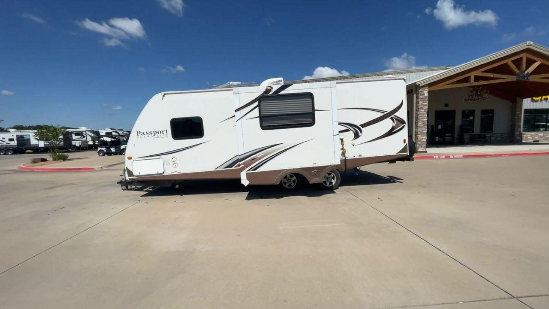 2014 WHITE KEYSTONE PASSPORT 2400BH (4YDT24029ET) , Length: 27.83 ft. | Dry Weight: 4,730 lbs. | Gross Weight: 6,800 lbs. | Slides: 1 transmission, located at 4319 N Main Street, Cleburne, TX, 76033, (817) 221-0660, 32.435829, -97.384178 - The 2014 Keystone Passport 2400BH is a dual-axle steel wheel set-up that measures 27.83 ft. in length. It has a dry weight of 4,730 lbs. and a GVWR of 6,800 lbs. It also has a payload capacity of 2,070 lbs. and a hitch weight of 515 lbs. Its exterior is a base color of white with black and brown acc - Photo#6