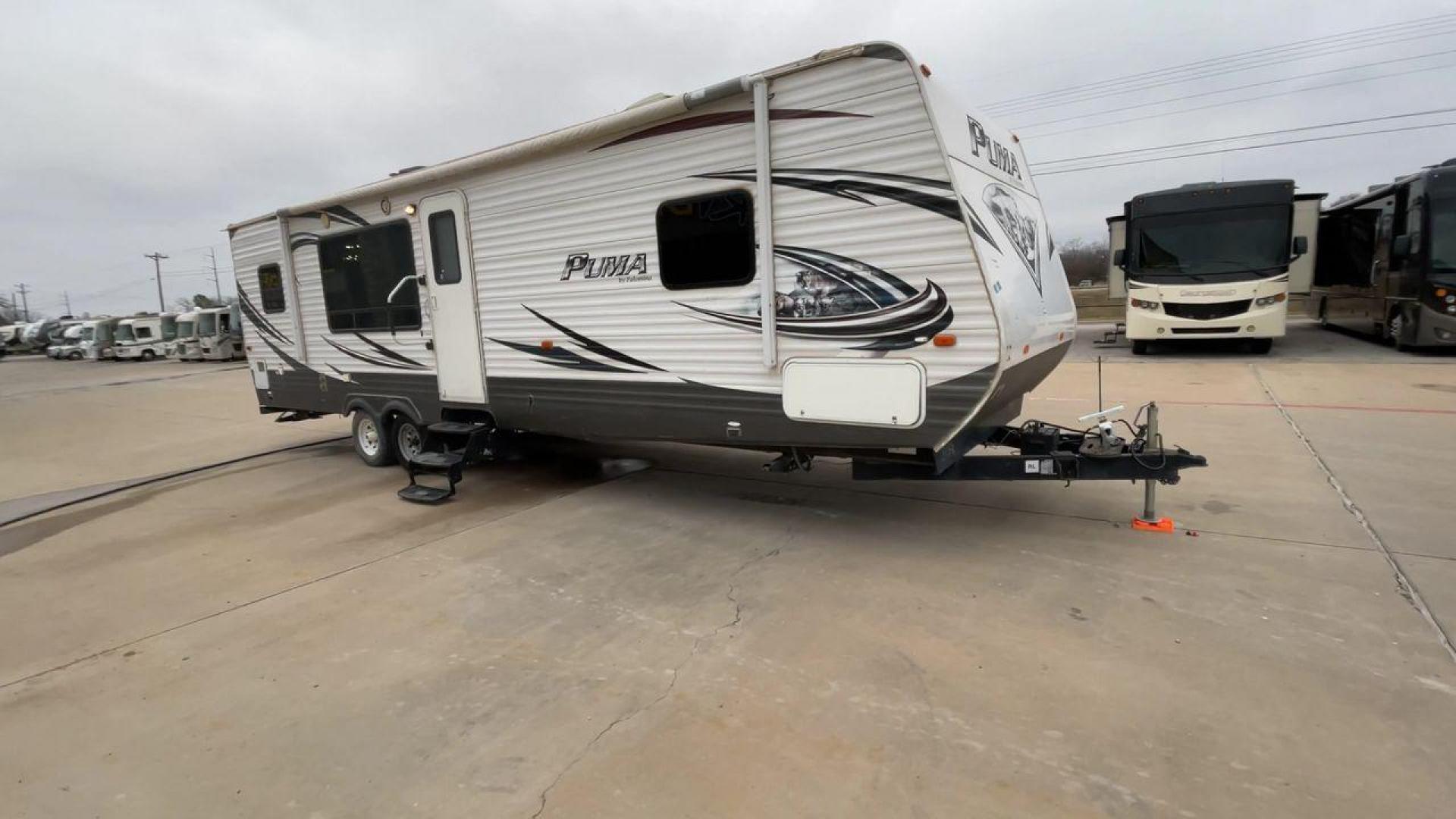 2014 WHITE PUMA 30RKSS (4X4TPUF23EP) , Length: 32.75 ft. | Dry Weight: 6,670 lbs. | Gross Weight: 9,827 lbs. | Slides: 1 transmission, located at 4319 N Main Street, Cleburne, TX, 76033, (817) 221-0660, 32.435829, -97.384178 - Looking for a travel trailer that offers comfort, convenience, and style? Look no further than this 2014 PUMA 30RKSS available at RV Depot in Cleburne, TX. With its spacious interior, sleek white exterior, and rear living layout, this travel trailer is perfect for your next adventure. The PUMA 30RK - Photo#3