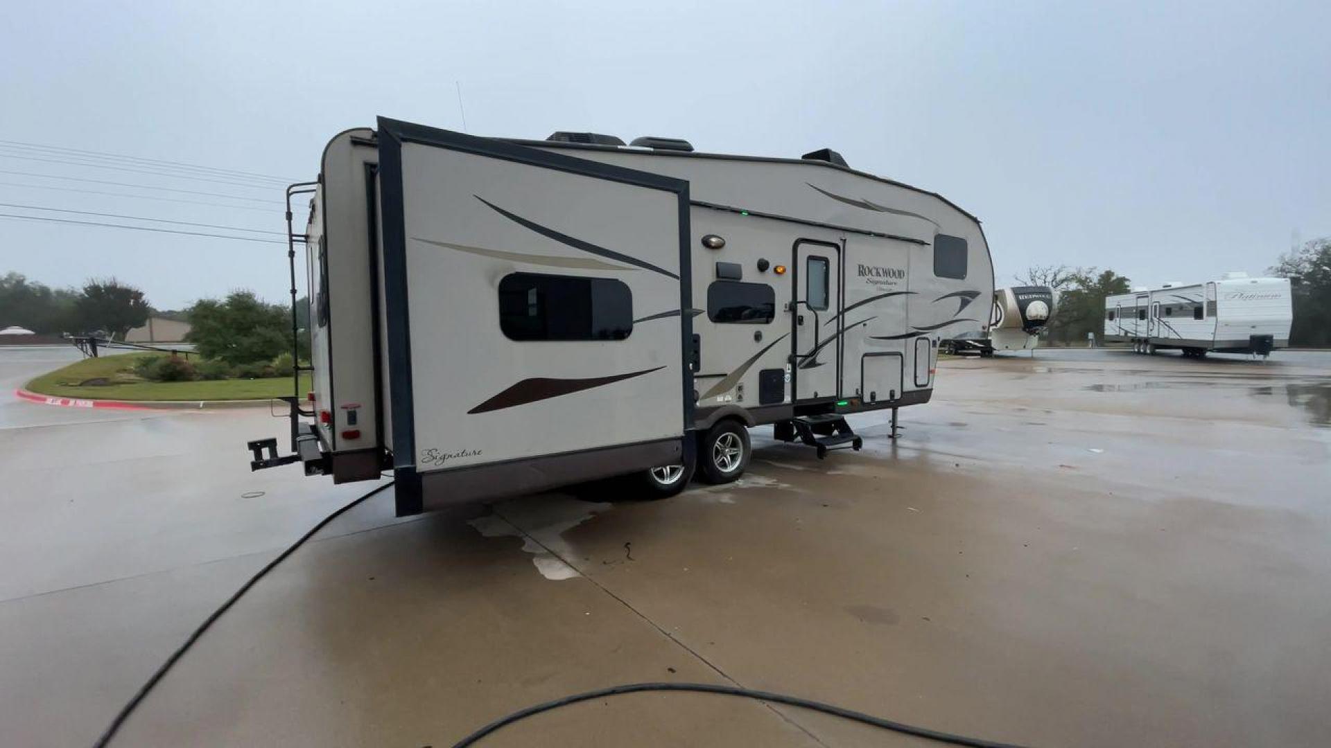 2014 TAN ROCKWOOD SIGNATURE 8281WS (4X4FRLD22E1) , Length: 31.92 ft. | Dry Weight: 7,849 lbs. | Slides: 3 transmission, located at 4319 N Main Street, Cleburne, TX, 76033, (817) 221-0660, 32.435829, -97.384178 - ARKANSAS TITLE, WILL NEED ORIGINAL INSPECTION - Photo#1