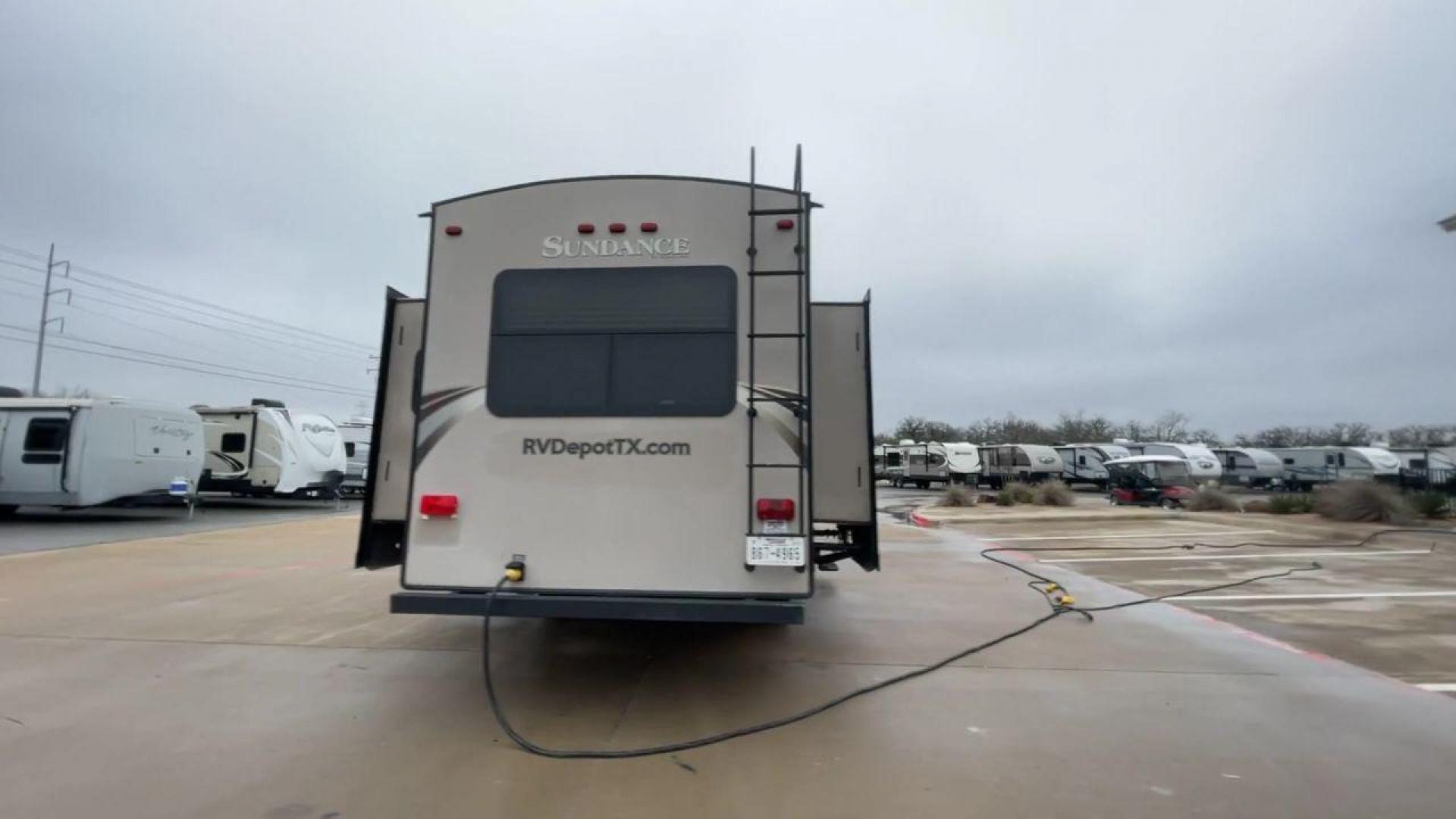 2014 TAN SUNDANCE 2880RLT (5SFSG3320EE) , Length: 32.2 ft. | Dry Weight: 9,750 lbs. | Gross Weight: 13,800 lbs. | Slides: 3 transmission, located at 4319 N Main Street, Cleburne, TX, 76033, (817) 221-0660, 32.435829, -97.384178 - This 2014 Sundance Fifth Wheel is just over 32 feet long and 8 feet wide. It has a GVWR of 13,800 lbs and a hitch weight of 2,220 lbs. The exterior of this fifth wheel is a stylish grey with brown, white, and beige decals. This model also has three slides and a 16-foot power-retractable awning. The - Photo#8