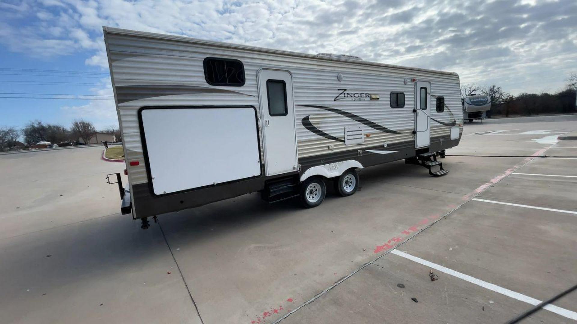 2014 TAN ZINGER 31SB (4V0TC3126EJ) , Length: 35.5 ft.| Dry Weight: 7,875 lbs. | Gross Weight: 9,671 lbs. | Slides: 2 transmission, located at 4319 N Main Street, Cleburne, TX, 76033, (817) 221-0660, 32.435829, -97.384178 - This 2014 CrossRoads Zinger 31SB travel trailer measures 35.5 feet. It is a dual axle, steel wheel setup with electric drum brakes. Its dry weight is 7,875 lbs. Its payload is 1,796 lbs, hitch weight is 1,071 lbs and the GVWR 9.671 lbs. The fiberglass exterior is painted white and tan with dark tan - Photo#1