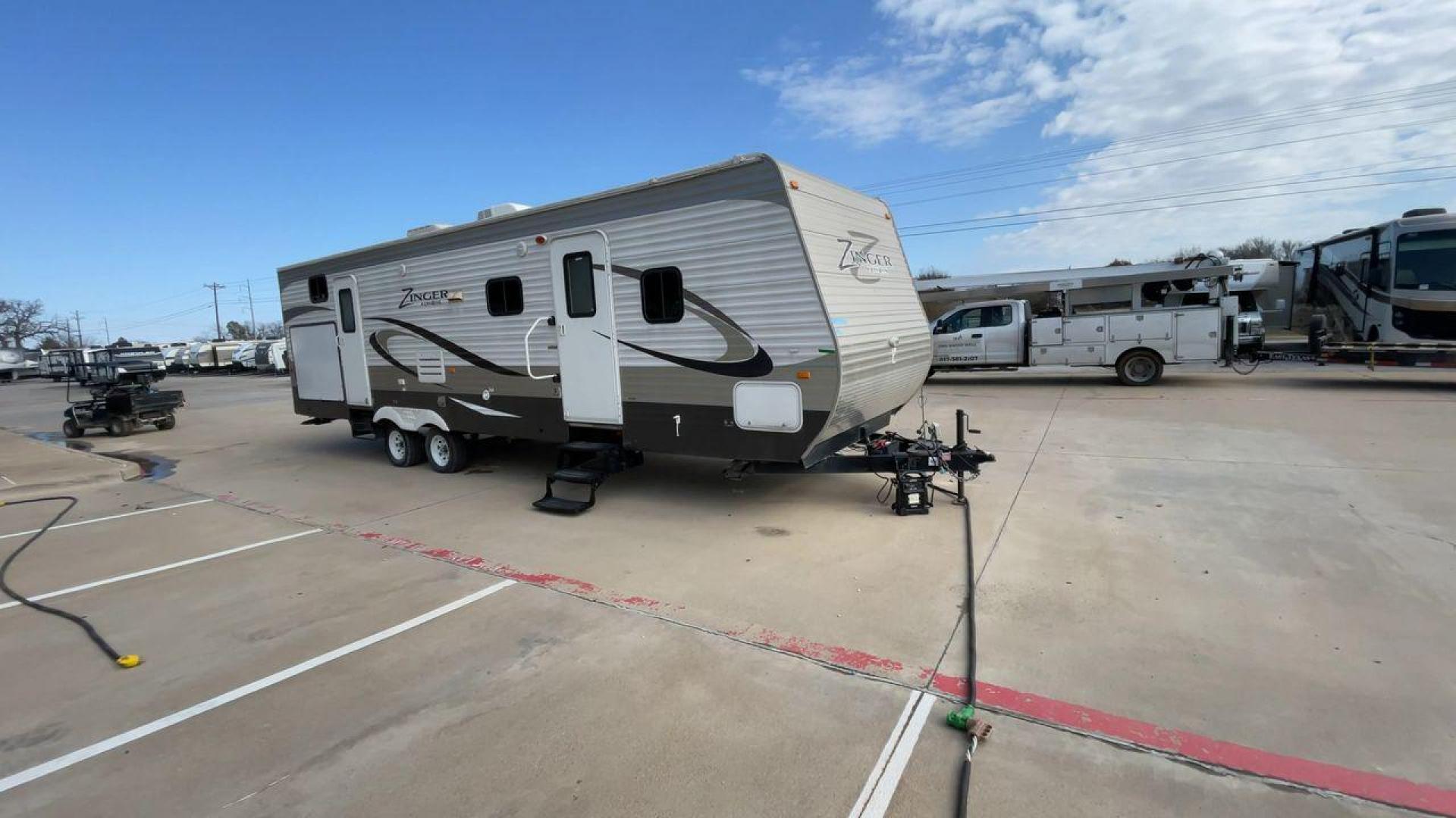 2014 TAN ZINGER 31SB (4V0TC3126EJ) , Length: 35.5 ft.| Dry Weight: 7,875 lbs. | Gross Weight: 9,671 lbs. | Slides: 2 transmission, located at 4319 N Main Street, Cleburne, TX, 76033, (817) 221-0660, 32.435829, -97.384178 - This 2014 CrossRoads Zinger 31SB travel trailer measures 35.5 feet. It is a dual axle, steel wheel setup with electric drum brakes. Its dry weight is 7,875 lbs. Its payload is 1,796 lbs, hitch weight is 1,071 lbs and the GVWR 9.671 lbs. The fiberglass exterior is painted white and tan with dark tan - Photo#3