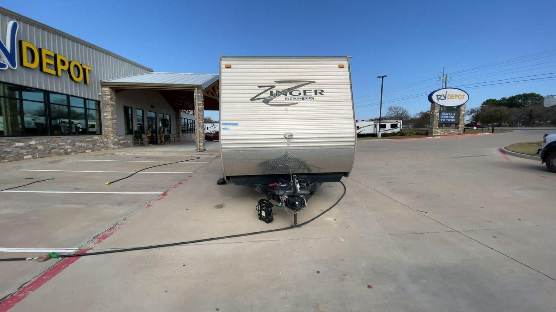 2014 TAN ZINGER 31SB (4V0TC3126EJ) , Length: 35.5 ft.| Dry Weight: 7,875 lbs. | Gross Weight: 9,671 lbs. | Slides: 2 transmission, located at 4319 N Main Street, Cleburne, TX, 76033, (817) 221-0660, 32.435829, -97.384178 - This 2014 CrossRoads Zinger 31SB travel trailer measures 35.5 feet. It is a dual axle, steel wheel setup with electric drum brakes. Its dry weight is 7,875 lbs. Its payload is 1,796 lbs, hitch weight is 1,071 lbs and the GVWR 9.671 lbs. The fiberglass exterior is painted white and tan with dark tan - Photo#4