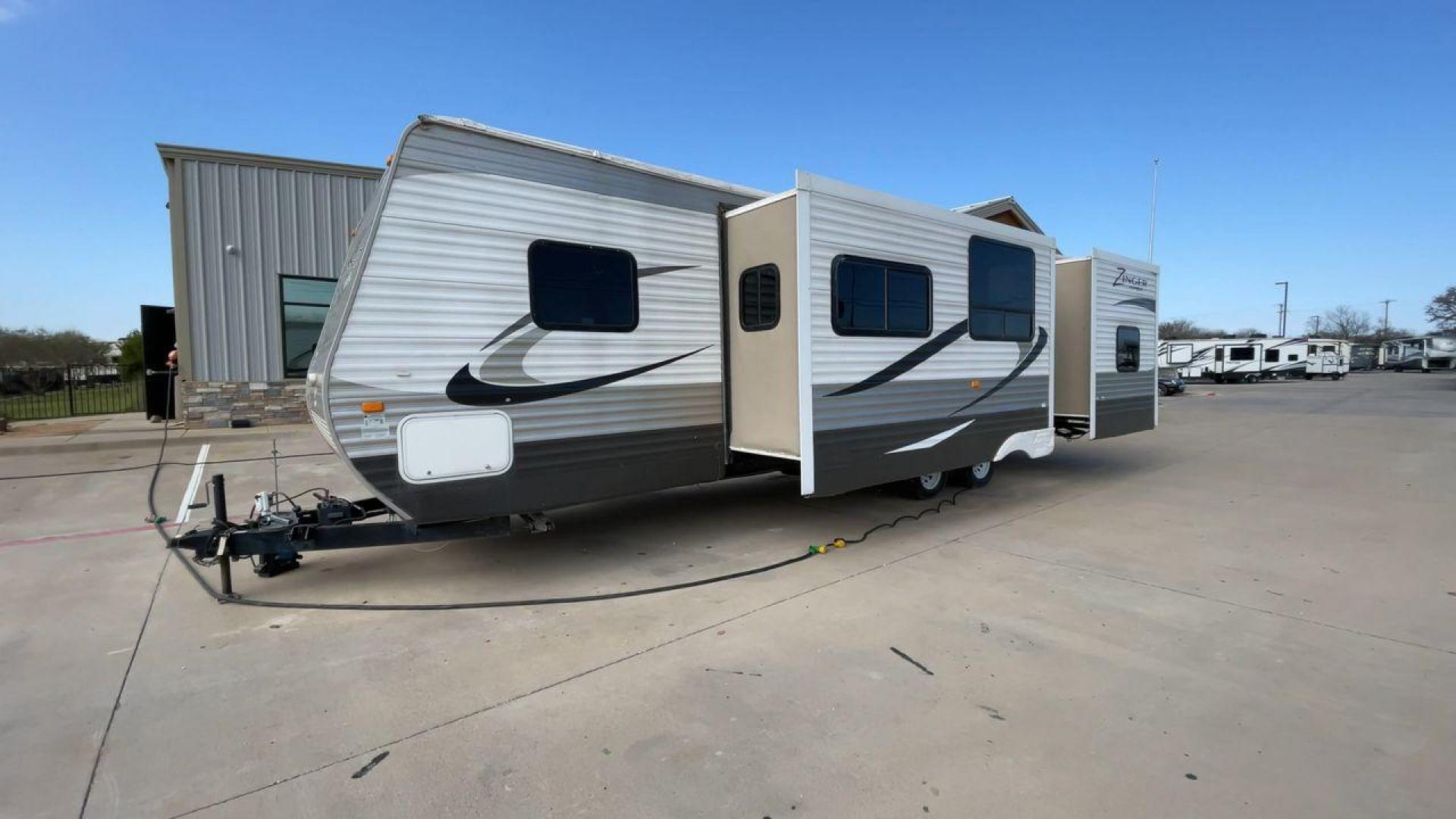 2014 TAN ZINGER 31SB (4V0TC3126EJ) , Length: 35.5 ft.| Dry Weight: 7,875 lbs. | Gross Weight: 9,671 lbs. | Slides: 2 transmission, located at 4319 N Main Street, Cleburne, TX, 76033, (817) 221-0660, 32.435829, -97.384178 - This 2014 CrossRoads Zinger 31SB travel trailer measures 35.5 feet. It is a dual axle, steel wheel setup with electric drum brakes. Its dry weight is 7,875 lbs. Its payload is 1,796 lbs, hitch weight is 1,071 lbs and the GVWR 9.671 lbs. The fiberglass exterior is painted white and tan with dark tan - Photo#5