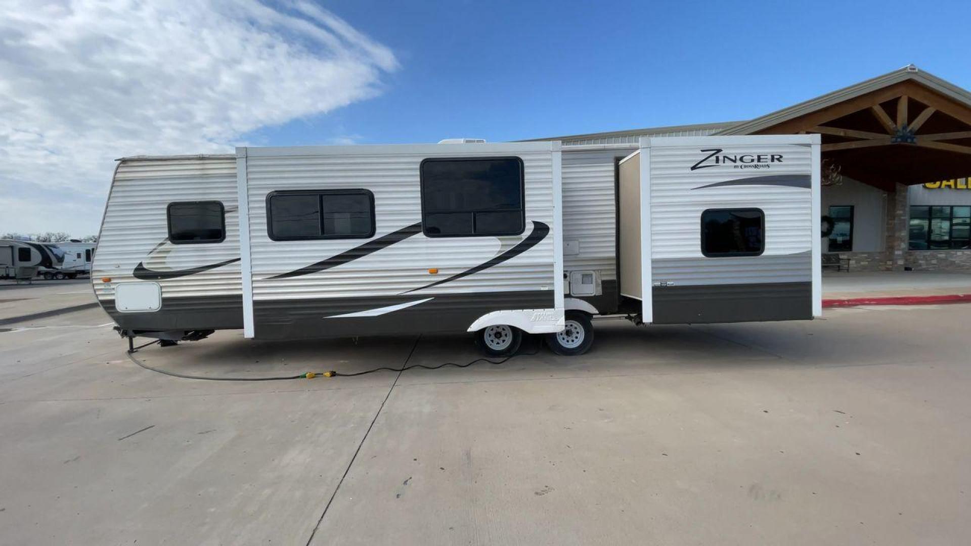 2014 TAN ZINGER 31SB (4V0TC3126EJ) , Length: 35.5 ft.| Dry Weight: 7,875 lbs. | Gross Weight: 9,671 lbs. | Slides: 2 transmission, located at 4319 N Main Street, Cleburne, TX, 76033, (817) 221-0660, 32.435829, -97.384178 - This 2014 CrossRoads Zinger 31SB travel trailer measures 35.5 feet. It is a dual axle, steel wheel setup with electric drum brakes. Its dry weight is 7,875 lbs. Its payload is 1,796 lbs, hitch weight is 1,071 lbs and the GVWR 9.671 lbs. The fiberglass exterior is painted white and tan with dark tan - Photo#6