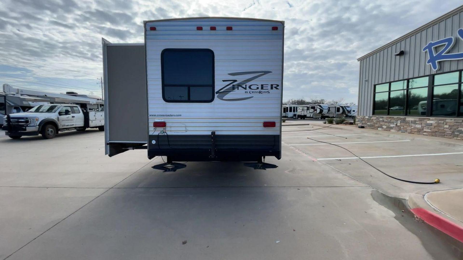 2014 TAN ZINGER 31SB (4V0TC3126EJ) , Length: 35.5 ft.| Dry Weight: 7,875 lbs. | Gross Weight: 9,671 lbs. | Slides: 2 transmission, located at 4319 N Main Street, Cleburne, TX, 76033, (817) 221-0660, 32.435829, -97.384178 - This 2014 CrossRoads Zinger 31SB travel trailer measures 35.5 feet. It is a dual axle, steel wheel setup with electric drum brakes. Its dry weight is 7,875 lbs. Its payload is 1,796 lbs, hitch weight is 1,071 lbs and the GVWR 9.671 lbs. The fiberglass exterior is painted white and tan with dark tan - Photo#8