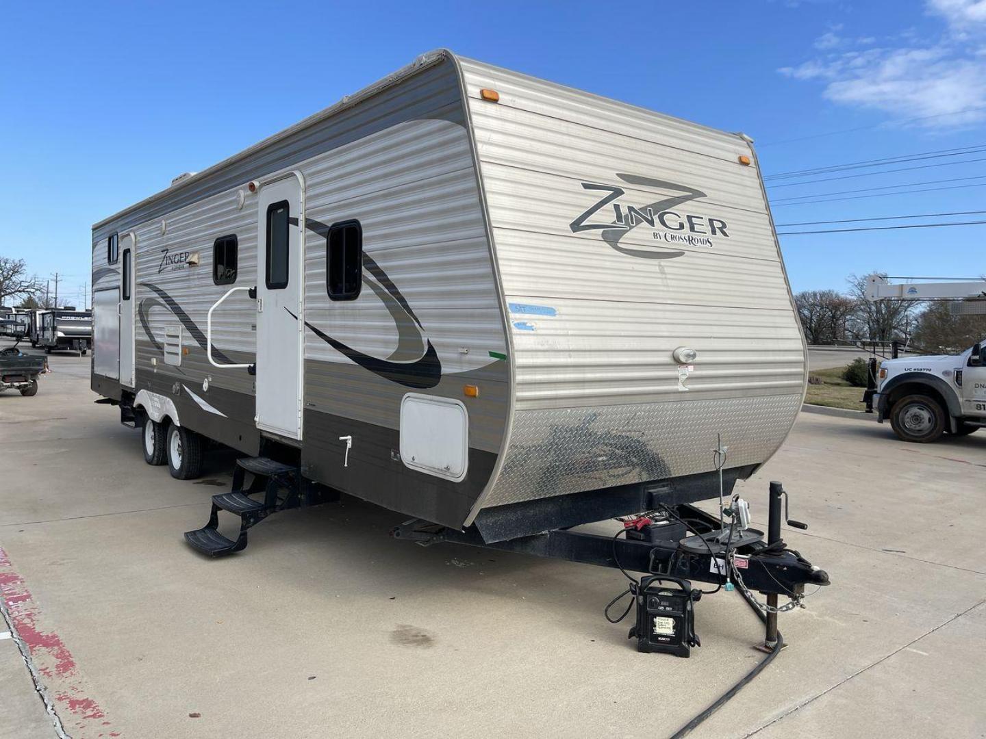 2014 TAN ZINGER 31SB (4V0TC3126EJ) , Length: 35.5 ft.| Dry Weight: 7,875 lbs. | Gross Weight: 9,671 lbs. | Slides: 2 transmission, located at 4319 N Main Street, Cleburne, TX, 76033, (817) 221-0660, 32.435829, -97.384178 - This 2014 CrossRoads Zinger 31SB travel trailer measures 35.5 feet. It is a dual axle, steel wheel setup with electric drum brakes. Its dry weight is 7,875 lbs. Its payload is 1,796 lbs, hitch weight is 1,071 lbs and the GVWR 9.671 lbs. The fiberglass exterior is painted white and tan with dark tan - Photo#22