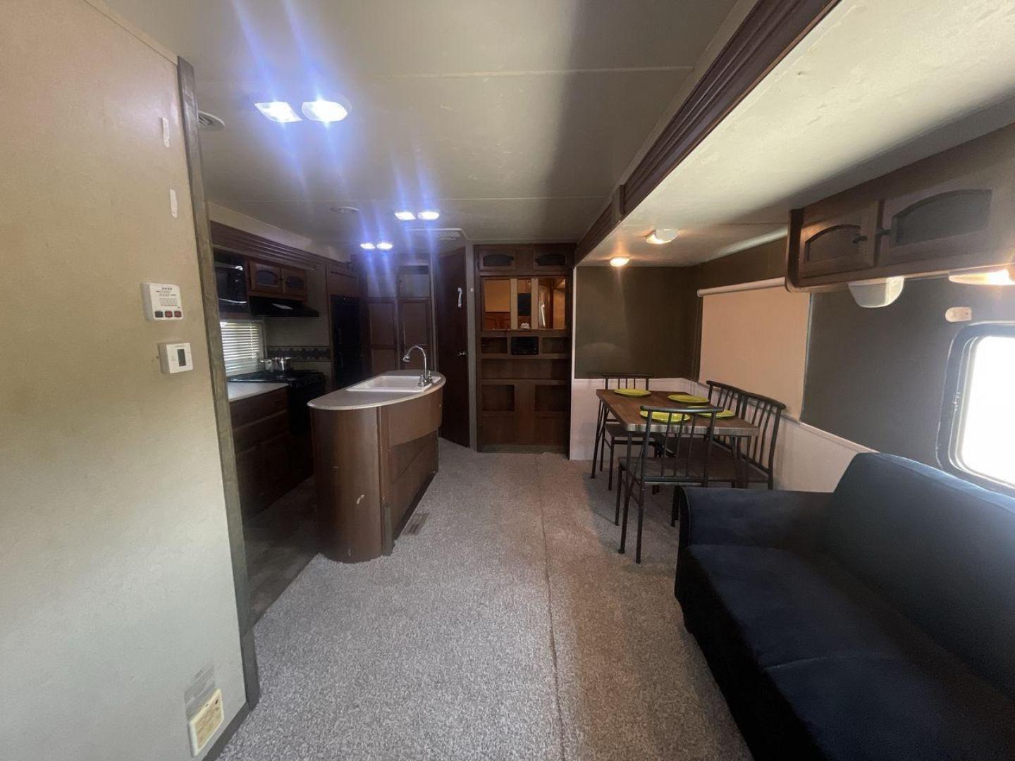 2015 TAN COACHMEN FREEDOM EXPRESS 320D (5ZT2FEXB6FA) , Length: 36.92 ft | Dry Weight: 7,374 lbs | Gross Weight: 10,700 lbs | Slides: 3 transmission, located at 4319 N Main Street, Cleburne, TX, 76033, (817) 221-0660, 32.435829, -97.384178 - The 2015 Coachmen Freedom Express 320BHDS travel trailer offers unsurpassed independence and comfort. With a length of 36.92 feet and three slides, this trailer provides ample living space for your entire family or company. Its aluminum body and fiberglass sidewalls are both robust and lightweight, - Photo#11