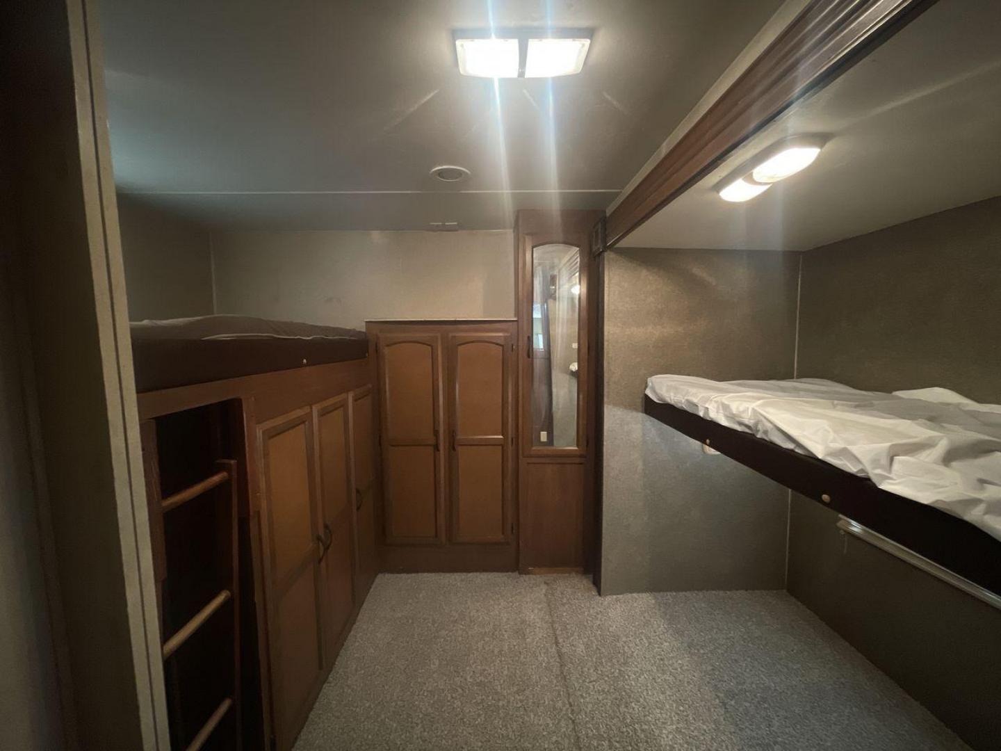 2015 TAN COACHMEN FREEDOM EXPRESS 320D (5ZT2FEXB6FA) , Length: 36.92 ft | Dry Weight: 7,374 lbs | Gross Weight: 10,700 lbs | Slides: 3 transmission, located at 4319 N Main Street, Cleburne, TX, 76033, (817) 221-0660, 32.435829, -97.384178 - The 2015 Coachmen Freedom Express 320BHDS travel trailer offers unsurpassed independence and comfort. With a length of 36.92 feet and three slides, this trailer provides ample living space for your entire family or company. Its aluminum body and fiberglass sidewalls are both robust and lightweight, - Photo#18