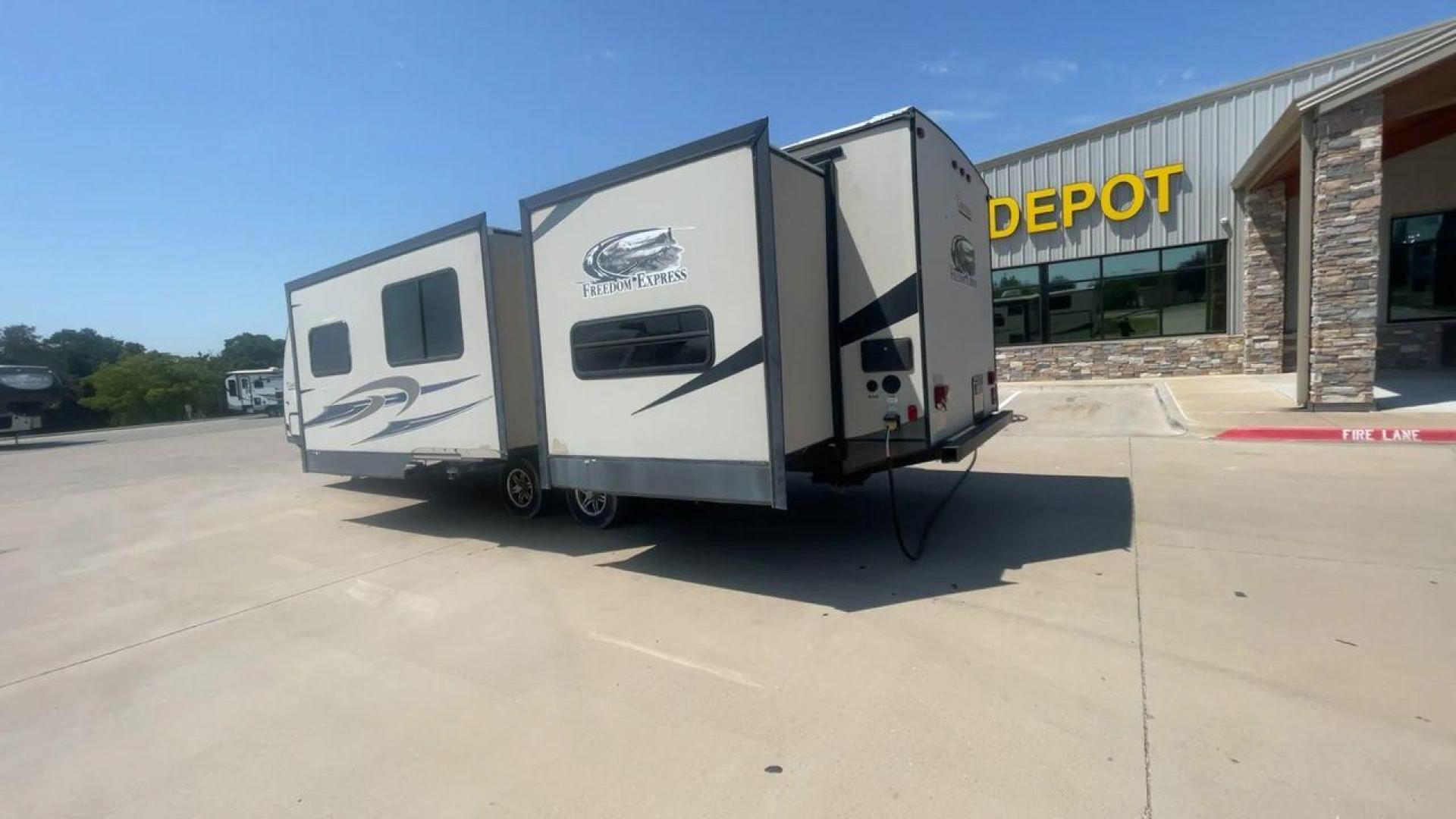 2015 TAN COACHMEN FREEDOM EXPRESS 320D (5ZT2FEXB6FA) , Length: 36.92 ft | Dry Weight: 7,374 lbs | Gross Weight: 10,700 lbs | Slides: 3 transmission, located at 4319 N Main Street, Cleburne, TX, 76033, (817) 221-0660, 32.435829, -97.384178 - The 2015 Coachmen Freedom Express 320BHDS travel trailer offers unsurpassed independence and comfort. With a length of 36.92 feet and three slides, this trailer provides ample living space for your entire family or company. Its aluminum body and fiberglass sidewalls are both robust and lightweight, - Photo#7