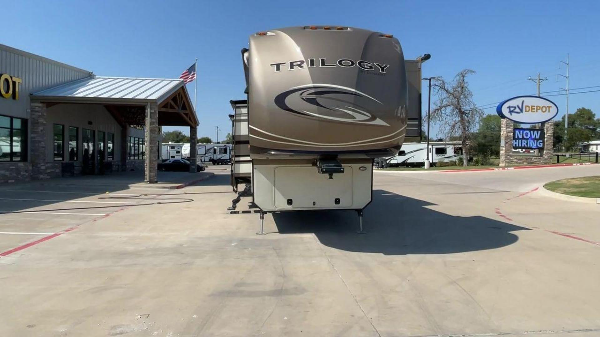 2015 TAN DYNAMAX TRILOGY 37BH - (5ZT3TL2B8FC) , Length: 42 ft. | Dry Weight: 15,638 lbs. | Gross Weight: 18,550 lbs. | Slides: 5 transmission, located at 4319 N Main Street, Cleburne, TX, 76033, (817) 221-0660, 32.435829, -97.384178 - This 2015 Trilogy Dynamax 37BH fifth wheel has 42.9 ft in length, 8.4 ft in width, and 13.2 ft in height. It has a dry weight of 15,638 lbs with a GVWR of 18,550 lbs and a hitch weight of 2,550 lbs. The exterior features a front storage capacity with a generator prep. It has extra-large pass-through - Photo#4