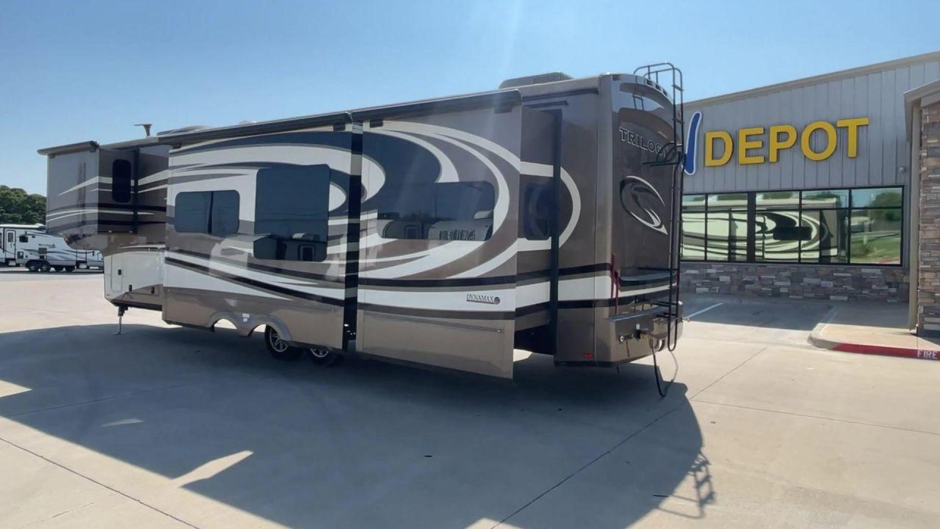 2015 TAN DYNAMAX TRILOGY 37BH - (5ZT3TL2B8FC) , Length: 42 ft. | Dry Weight: 15,638 lbs. | Gross Weight: 18,550 lbs. | Slides: 5 transmission, located at 4319 N Main Street, Cleburne, TX, 76033, (817) 221-0660, 32.435829, -97.384178 - This 2015 Trilogy Dynamax 37BH fifth wheel has 42.9 ft in length, 8.4 ft in width, and 13.2 ft in height. It has a dry weight of 15,638 lbs with a GVWR of 18,550 lbs and a hitch weight of 2,550 lbs. The exterior features a front storage capacity with a generator prep. It has extra-large pass-through - Photo#7