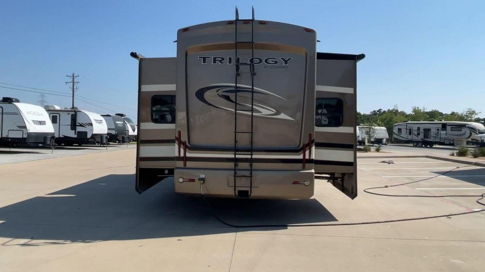 2015 TAN DYNAMAX TRILOGY 37BH - (5ZT3TL2B8FC) , Length: 42 ft. | Dry Weight: 15,638 lbs. | Gross Weight: 18,550 lbs. | Slides: 5 transmission, located at 4319 N Main Street, Cleburne, TX, 76033, (817) 221-0660, 32.435829, -97.384178 - This 2015 Trilogy Dynamax 37BH fifth wheel has 42.9 ft in length, 8.4 ft in width, and 13.2 ft in height. It has a dry weight of 15,638 lbs with a GVWR of 18,550 lbs and a hitch weight of 2,550 lbs. The exterior features a front storage capacity with a generator prep. It has extra-large pass-through - Photo#8