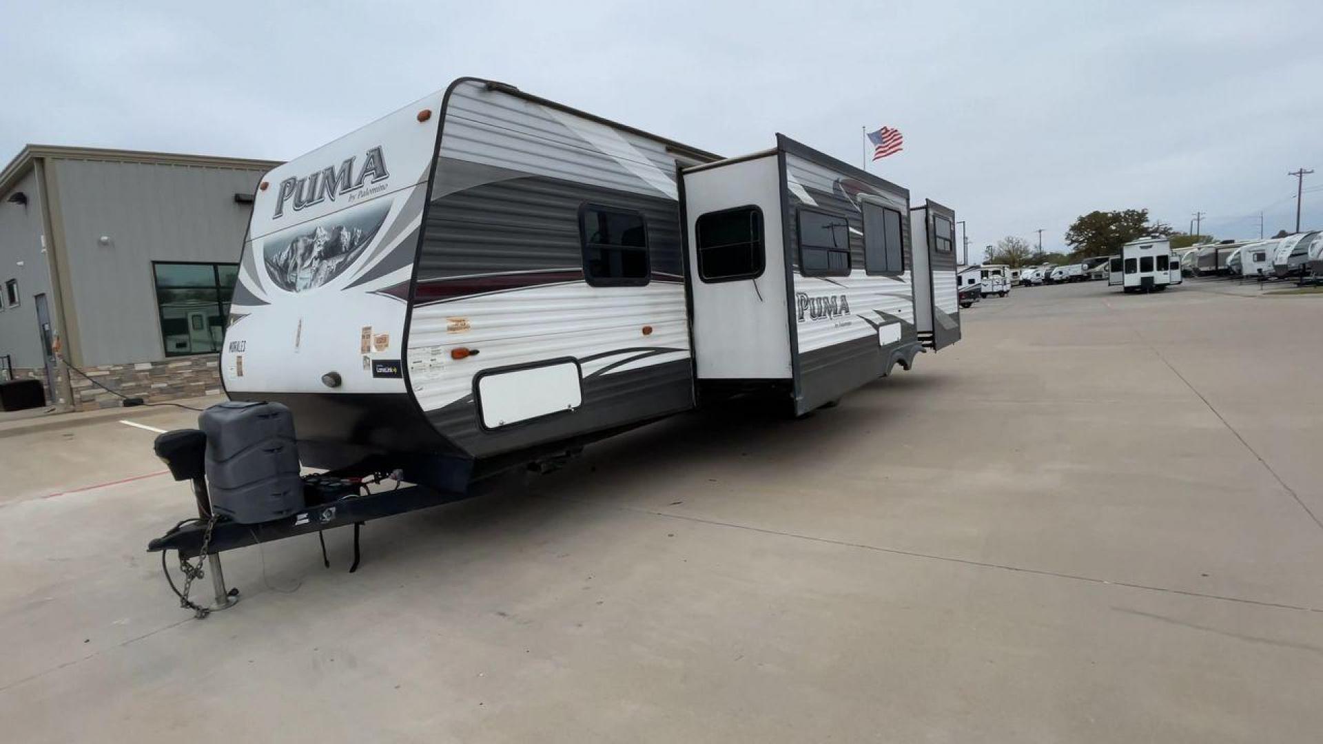 2015 FOREST RIVER PUMA 31BHSS (4X4TPUG21FP) , Length: 35.33 ft. | Dry Weight: 7,702 lbs. | Gross Weight: 10,236 lbs. | Slides: 2 transmission, located at 4319 N Main Street, Cleburne, TX, 76033, (817) 221-0660, 32.435829, -97.384178 - The 2015 Forest River Puma 31BH RV features a classic and durable exterior design. The body of the RV is a combination of gray, white, and black with accents of maroon, which gives it a rugged yet stylish look. The sides have aluminum panels with a ribbed texture, which not only adds to the aestheti - Photo#5