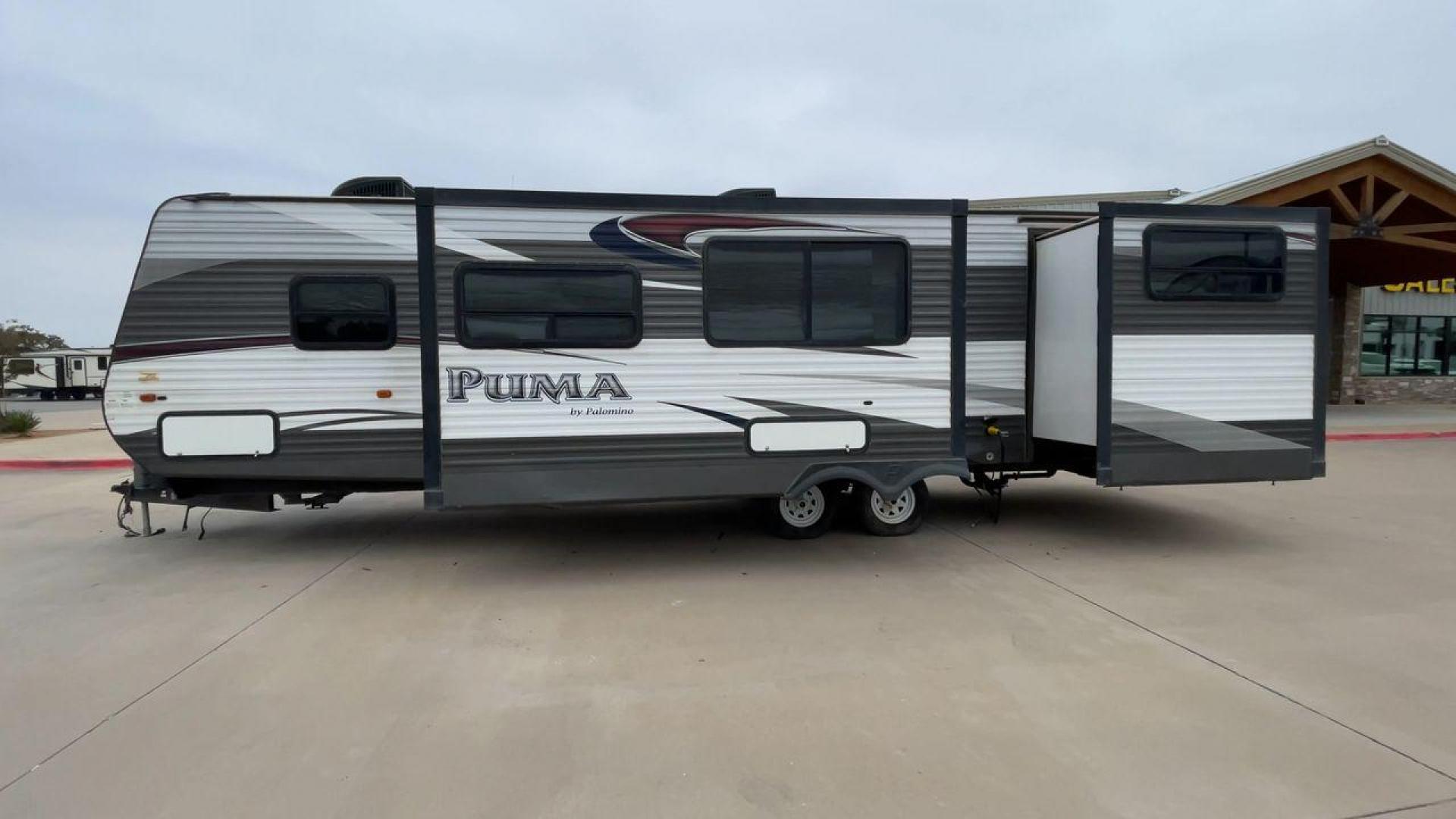 2015 FOREST RIVER PUMA 31BHSS (4X4TPUG21FP) , Length: 35.33 ft. | Dry Weight: 7,702 lbs. | Gross Weight: 10,236 lbs. | Slides: 2 transmission, located at 4319 N Main Street, Cleburne, TX, 76033, (817) 221-0660, 32.435829, -97.384178 - The 2015 Forest River Puma 31BH RV features a classic and durable exterior design. The body of the RV is a combination of gray, white, and black with accents of maroon, which gives it a rugged yet stylish look. The sides have aluminum panels with a ribbed texture, which not only adds to the aestheti - Photo#6