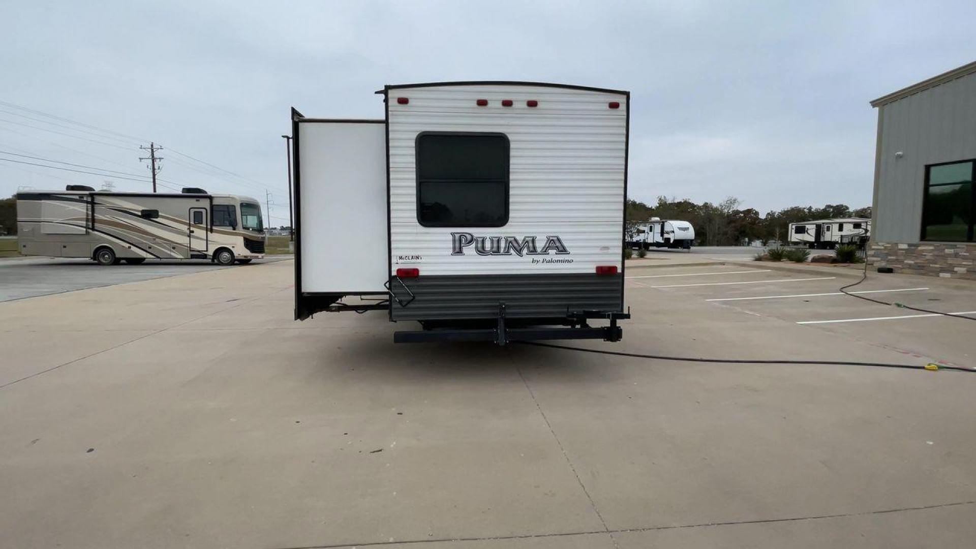 2015 FOREST RIVER PUMA 31BHSS (4X4TPUG21FP) , Length: 35.33 ft. | Dry Weight: 7,702 lbs. | Gross Weight: 10,236 lbs. | Slides: 2 transmission, located at 4319 N Main Street, Cleburne, TX, 76033, (817) 221-0660, 32.435829, -97.384178 - The 2015 Forest River Puma 31BH RV features a classic and durable exterior design. The body of the RV is a combination of gray, white, and black with accents of maroon, which gives it a rugged yet stylish look. The sides have aluminum panels with a ribbed texture, which not only adds to the aestheti - Photo#8