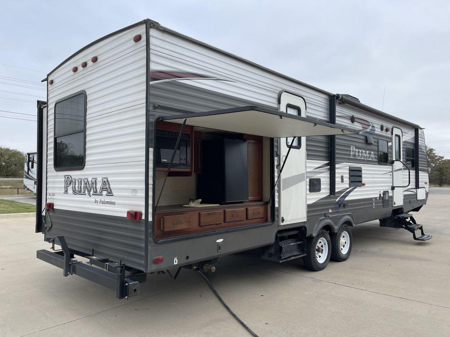 2015 FOREST RIVER PUMA 31BHSS (4X4TPUG21FP) , Length: 35.33 ft. | Dry Weight: 7,702 lbs. | Gross Weight: 10,236 lbs. | Slides: 2 transmission, located at 4319 N Main Street, Cleburne, TX, 76033, (817) 221-0660, 32.435829, -97.384178 - The 2015 Forest River Puma 31BH RV features a classic and durable exterior design. The body of the RV is a combination of gray, white, and black with accents of maroon, which gives it a rugged yet stylish look. The sides have aluminum panels with a ribbed texture, which not only adds to the aestheti - Photo#25