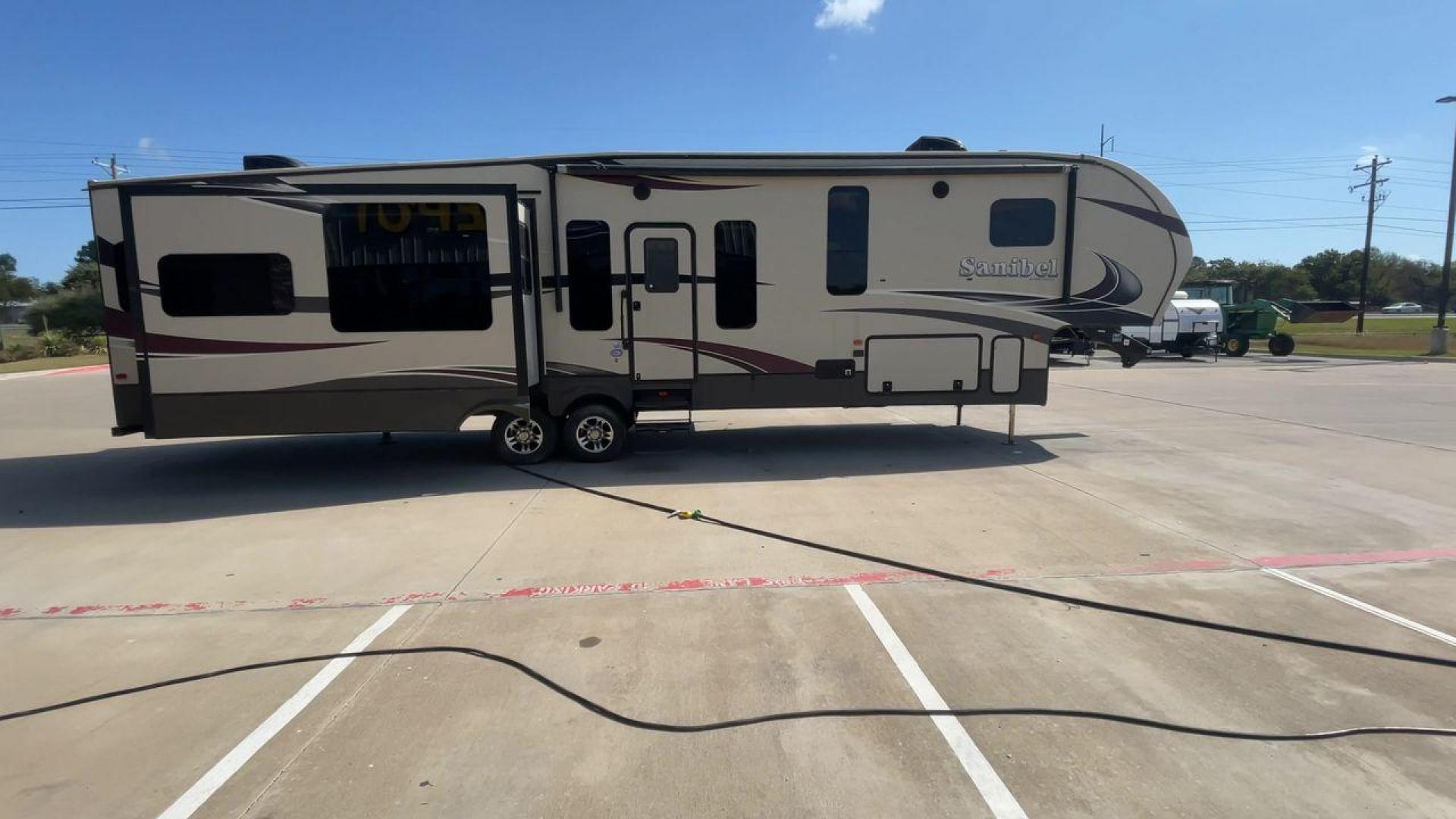 2015 FOREST RIVER SANIBEL 38QB (5ZT3SN3B4FG) , Length: 42.5 ft. | Dry Weight: 12,913 lbs. | Slides: 4 transmission, located at 4319 N Main Street, Cleburne, TX, 76033, (817) 221-0660, 32.435829, -97.384178 - The 2015 Prime Time Sanibel 38QB stands out with its spacious and functional design. It measures 42.5 feet in length and weighs 12,913 pounds. This fifth wheel features four slides that significantly expand the interior space. Its exterior showcases an aerodynamic front cap and stylish graphics. Ins - Photo#2