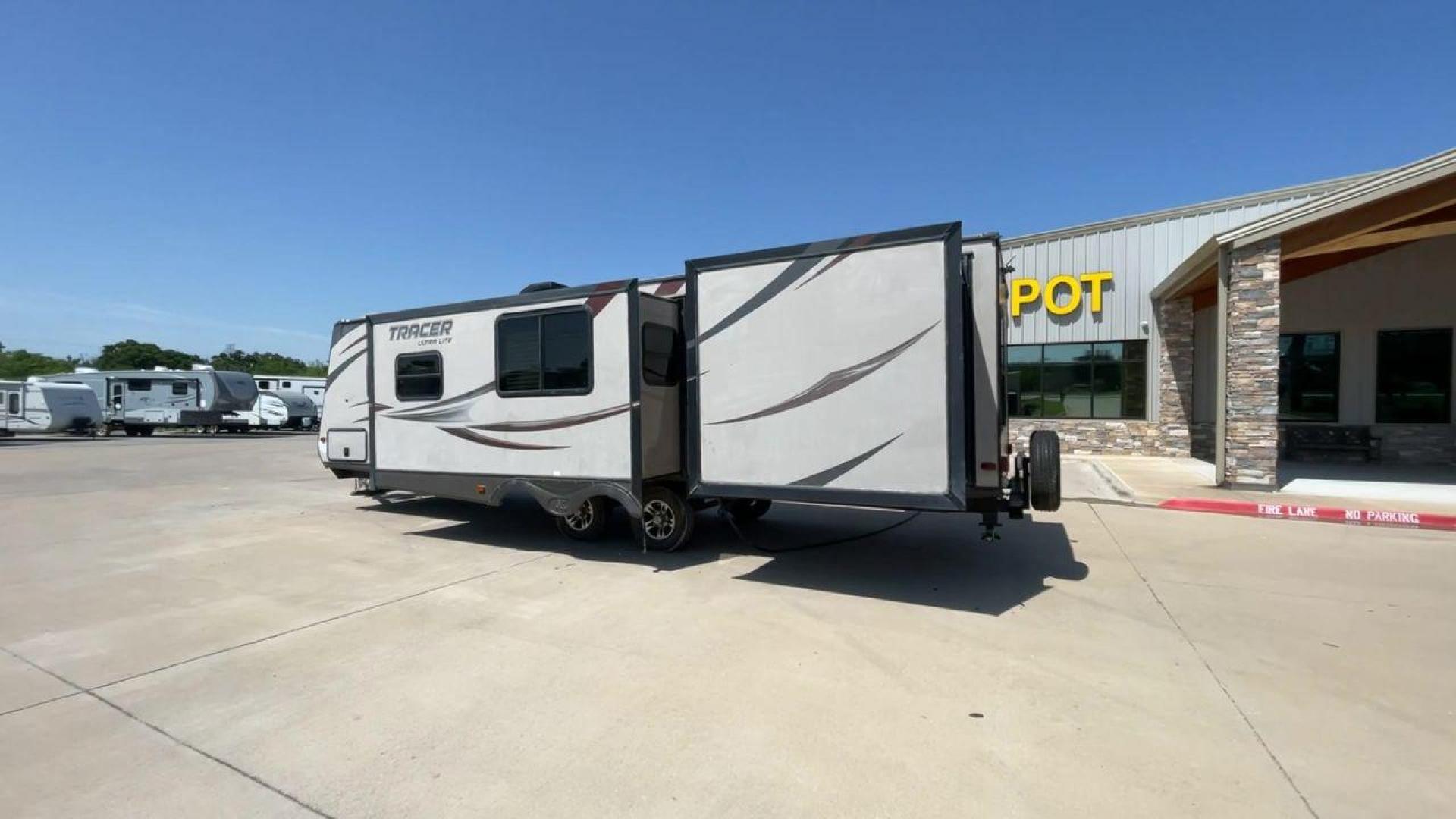 2015 WHITE FOREST RIVER TRACER 3150BHD (5ZT2TRXB5FB) , Length: 34 ft. | Dry Weight: 6,955 lbs. | Slides: 2 transmission, located at 4319 N Main Street, Cleburne, TX, 76033, (817) 221-0660, 32.435829, -97.384178 - In this 2015 Forest River Tracer 3150BHD, you are guaranteed more campers, more features, and more fun! This travel trailer measures exactly 34 ft. in length with a dry weight of 6,955 lbs. and a payload capacity of 2,755 lbs. It includes two doors, two slides, and one awning. This model featu - Photo#7