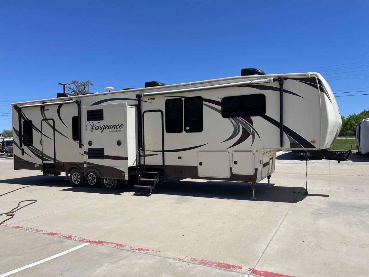 2015 TAN FOREST RIVER VENGEANCE - (4X4FVGR30FR) , Length: 42.83 ft. | Dry Weight: 14,270 lbs. | Gross Weight: 17,500 lbs. | Slides: 3 transmission, located at 4319 N Main Street, Cleburne, TX, 76033, (817) 221-0660, 32.435829, -97.384178 - Designed to provide comfort and adventure to your travels, the 2015 Forest River Vengeance 39B12 is a tough and adaptable fifth wheel toy hauler. With a dry weight of 14,270 pounds and a length of a little over 42 feet, this model offers plenty of room for your belongings while still being towable - Photo#22