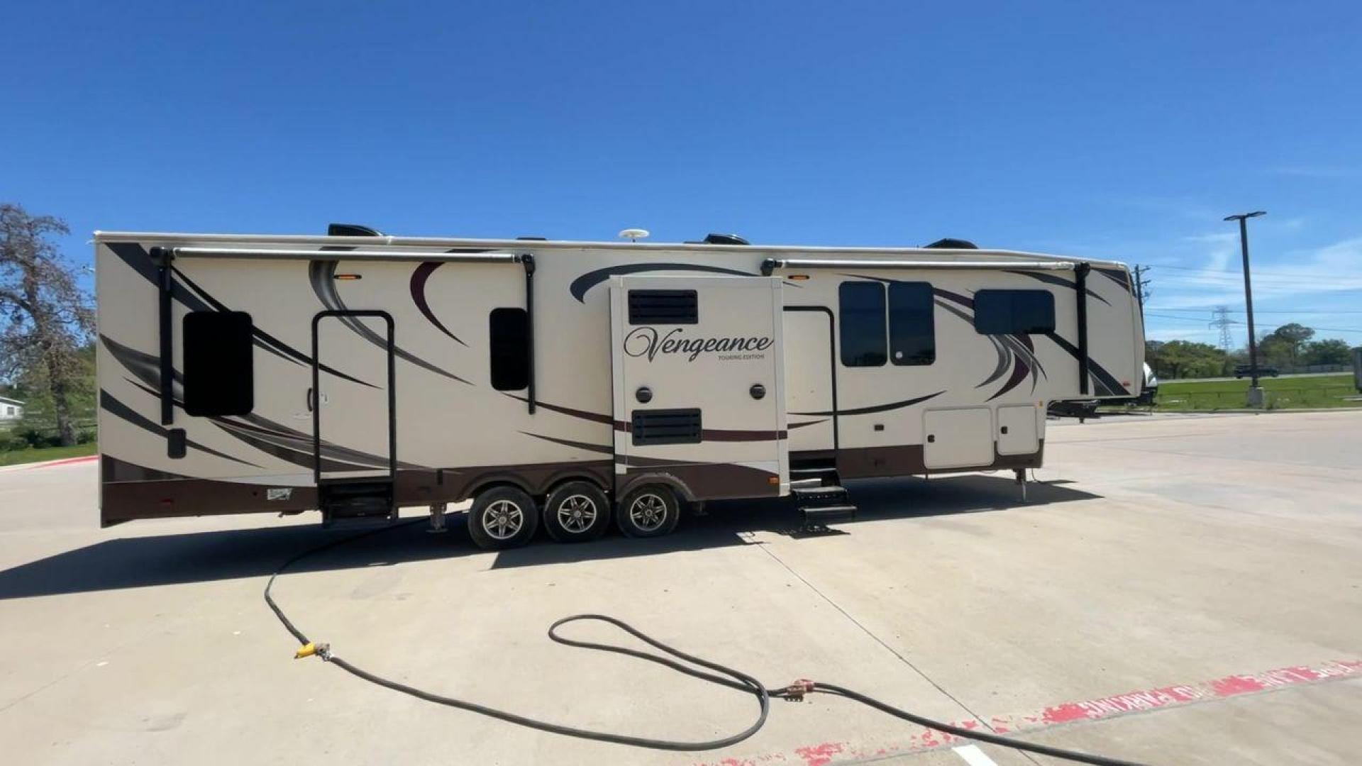 2015 TAN FOREST RIVER VENGEANCE - (4X4FVGR30FR) , Length: 42.83 ft. | Dry Weight: 14,270 lbs. | Gross Weight: 17,500 lbs. | Slides: 3 transmission, located at 4319 N Main Street, Cleburne, TX, 76033, (817) 221-0660, 32.435829, -97.384178 - Designed to provide comfort and adventure to your travels, the 2015 Forest River Vengeance 39B12 is a tough and adaptable fifth wheel toy hauler. With a dry weight of 14,270 pounds and a length of a little over 42 feet, this model offers plenty of room for your belongings while still being towable - Photo#2