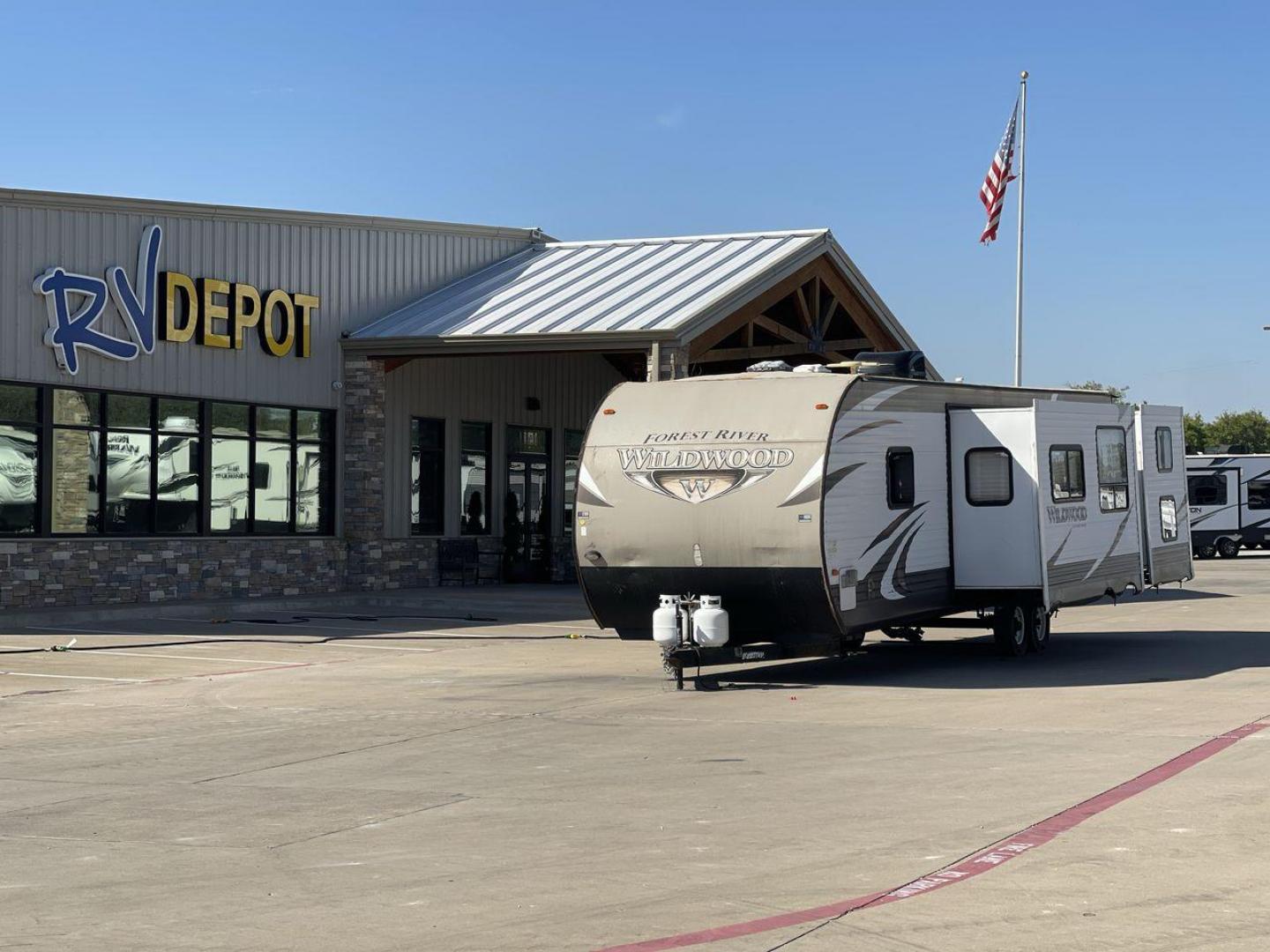 2015 FOREST RIVER WILDWOOD T (4X4TWDG2XF8) , Length: 35.67 ft. | Dry Weight: 8,350 lbs. | Slides: 3 transmission, located at 4319 N Main Street, Cleburne, TX, 76033, (817) 221-0660, 32.435829, -97.384178 - The 2015 Forest River Wildwood 31BKIS is a spacious and feature-packed travel trailer designed for comfort and family fun. With a length of 35.67 ft. and a dry weight of 8,350 lbs., this trailer is well-suited for extended stays or large families, offering plenty of room to relax. The exterior showc - Photo#0