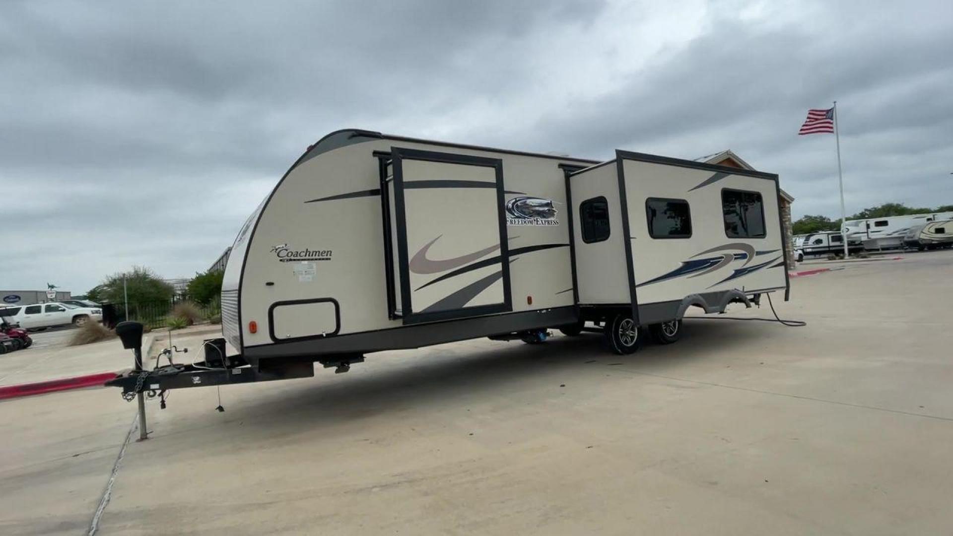 2015 TAN FREEDOM EXPRESS 305RKDS (5ZT2FEWB1FA) , Length: 34.5 ft. | Dry Weight: 6,199 lbs | Gross Weight: 9,500 lbs. | Slides: 2 transmission, located at 4319 N Main Street, Cleburne, TX, 76033, (817) 221-0660, 32.435829, -97.384178 - The 2015 Freedom Express 305RKDS is a travel trailer designed to deliver an exceptional camping experience, combining freedom and comfort in every detail. It boasts a rear kitchen layout, providing a unique and functional living space. The rear kitchen is equipped with high-end appliances, ample cou - Photo#0