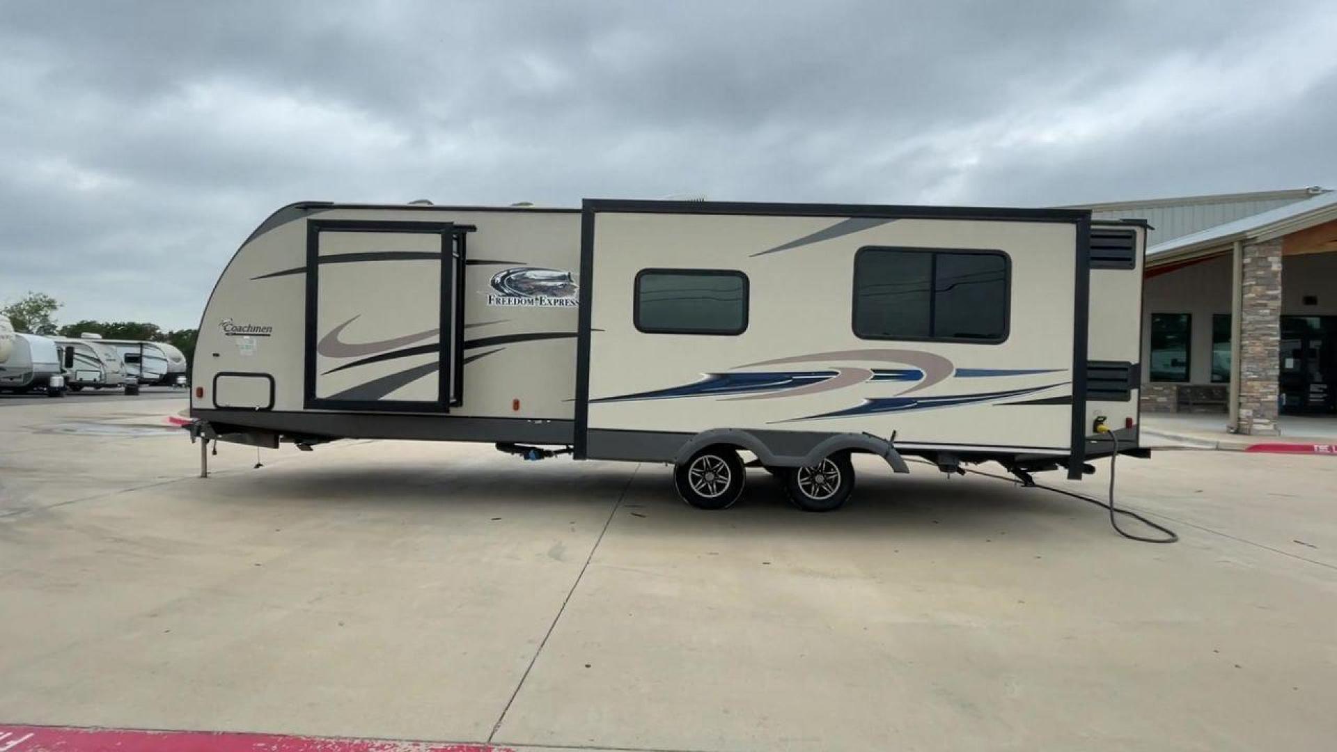 2015 TAN FREEDOM EXPRESS 305RKDS (5ZT2FEWB1FA) , Length: 34.5 ft. | Dry Weight: 6,199 lbs | Gross Weight: 9,500 lbs. | Slides: 2 transmission, located at 4319 N Main Street, Cleburne, TX, 76033, (817) 221-0660, 32.435829, -97.384178 - The 2015 Freedom Express 305RKDS is a travel trailer designed to deliver an exceptional camping experience, combining freedom and comfort in every detail. It boasts a rear kitchen layout, providing a unique and functional living space. The rear kitchen is equipped with high-end appliances, ample cou - Photo#1