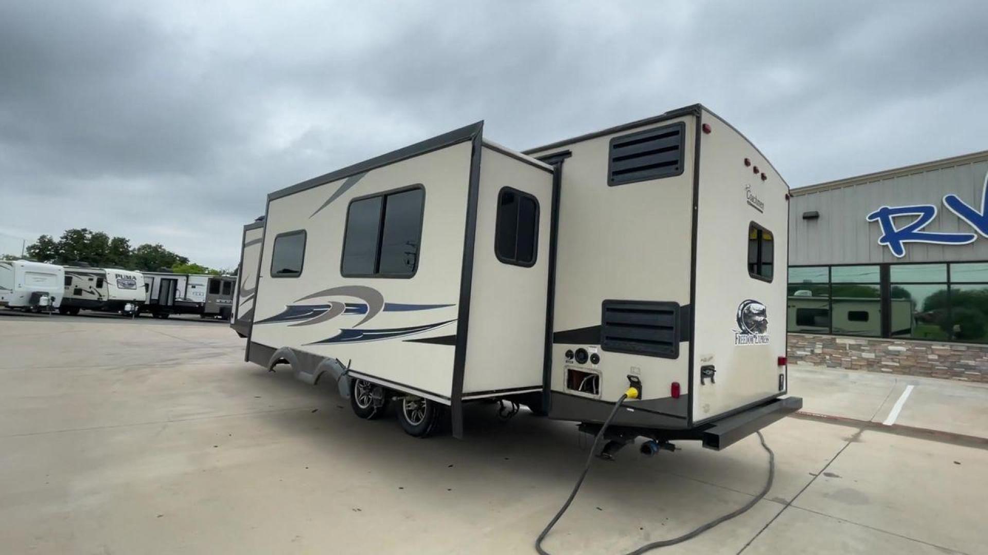 2015 TAN FREEDOM EXPRESS 305RKDS (5ZT2FEWB1FA) , Length: 34.5 ft. | Dry Weight: 6,199 lbs | Gross Weight: 9,500 lbs. | Slides: 2 transmission, located at 4319 N Main Street, Cleburne, TX, 76033, (817) 221-0660, 32.435829, -97.384178 - The 2015 Freedom Express 305RKDS is a travel trailer designed to deliver an exceptional camping experience, combining freedom and comfort in every detail. It boasts a rear kitchen layout, providing a unique and functional living space. The rear kitchen is equipped with high-end appliances, ample cou - Photo#2