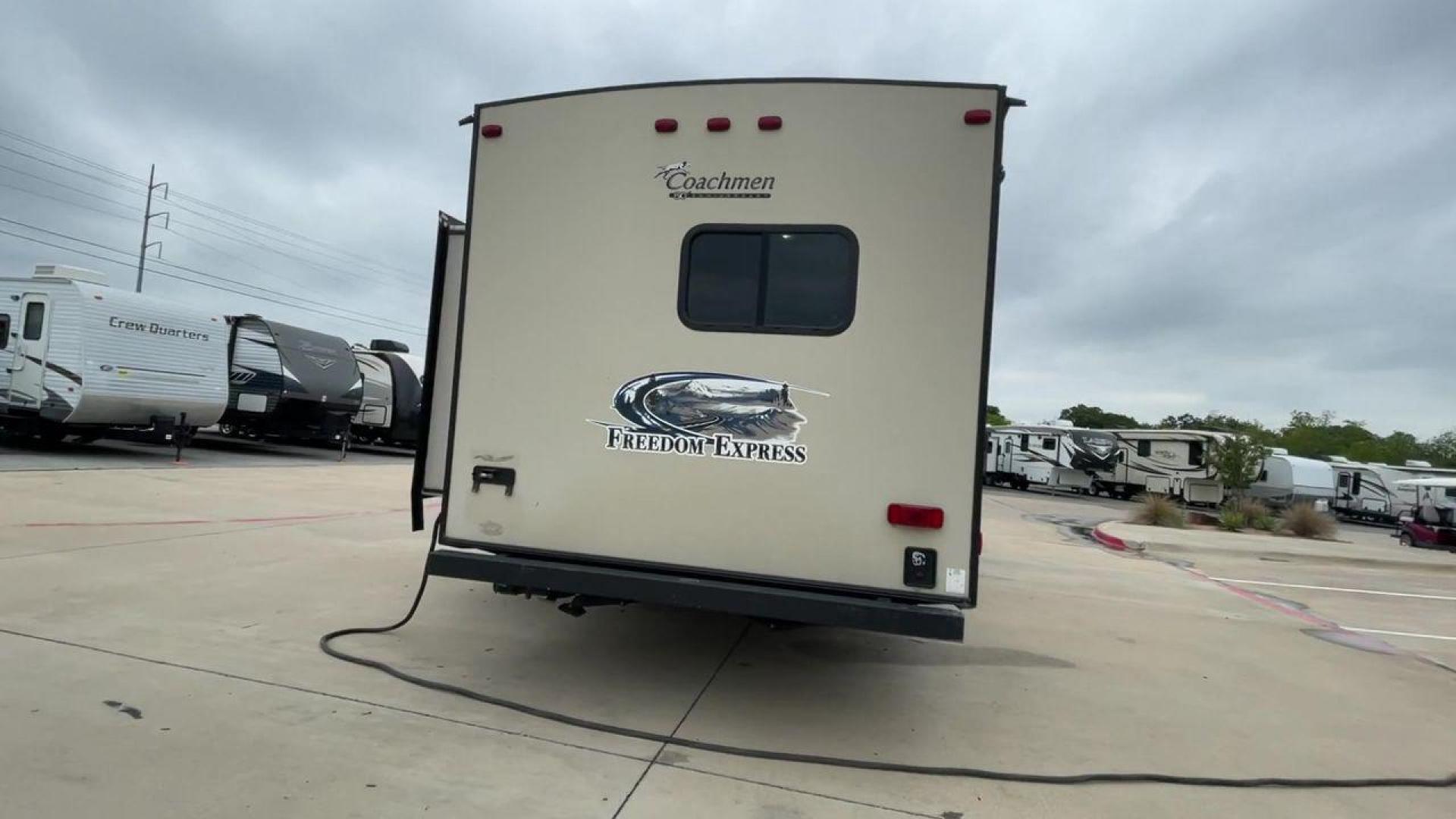 2015 TAN FREEDOM EXPRESS 305RKDS (5ZT2FEWB1FA) , Length: 34.5 ft. | Dry Weight: 6,199 lbs | Gross Weight: 9,500 lbs. | Slides: 2 transmission, located at 4319 N Main Street, Cleburne, TX, 76033, (817) 221-0660, 32.435829, -97.384178 - The 2015 Freedom Express 305RKDS is a travel trailer designed to deliver an exceptional camping experience, combining freedom and comfort in every detail. It boasts a rear kitchen layout, providing a unique and functional living space. The rear kitchen is equipped with high-end appliances, ample cou - Photo#3