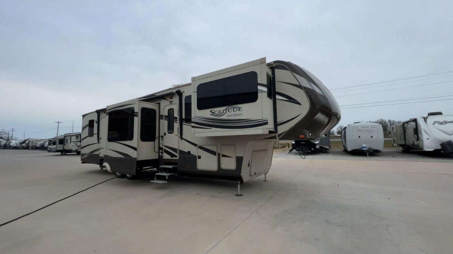 2015 BEIGE GRAND DESIGN SOLITUDE 379FL (573FS4325F1) , Length: 42.5 ft. | Dry Weight: 13,800 lbs. | Gross Weight: 16,000 lbs. | Slides: 5 transmission, located at 4319 N Main Street, Cleburne, TX, 76033, (817) 221-0660, 32.435829, -97.384178 - This 2015 GRSL Solitude 379 fifth wheel measures just over 42' in length. It is a dual axle and aluminum wheel setup with a GCWR of 16,000 lbs and a carrying capacity of 2,200 lbs. With five slides, this fifth wheel is spacious and comfortable! The Solitude's exterior is made from fiberglass, finish - Photo#3