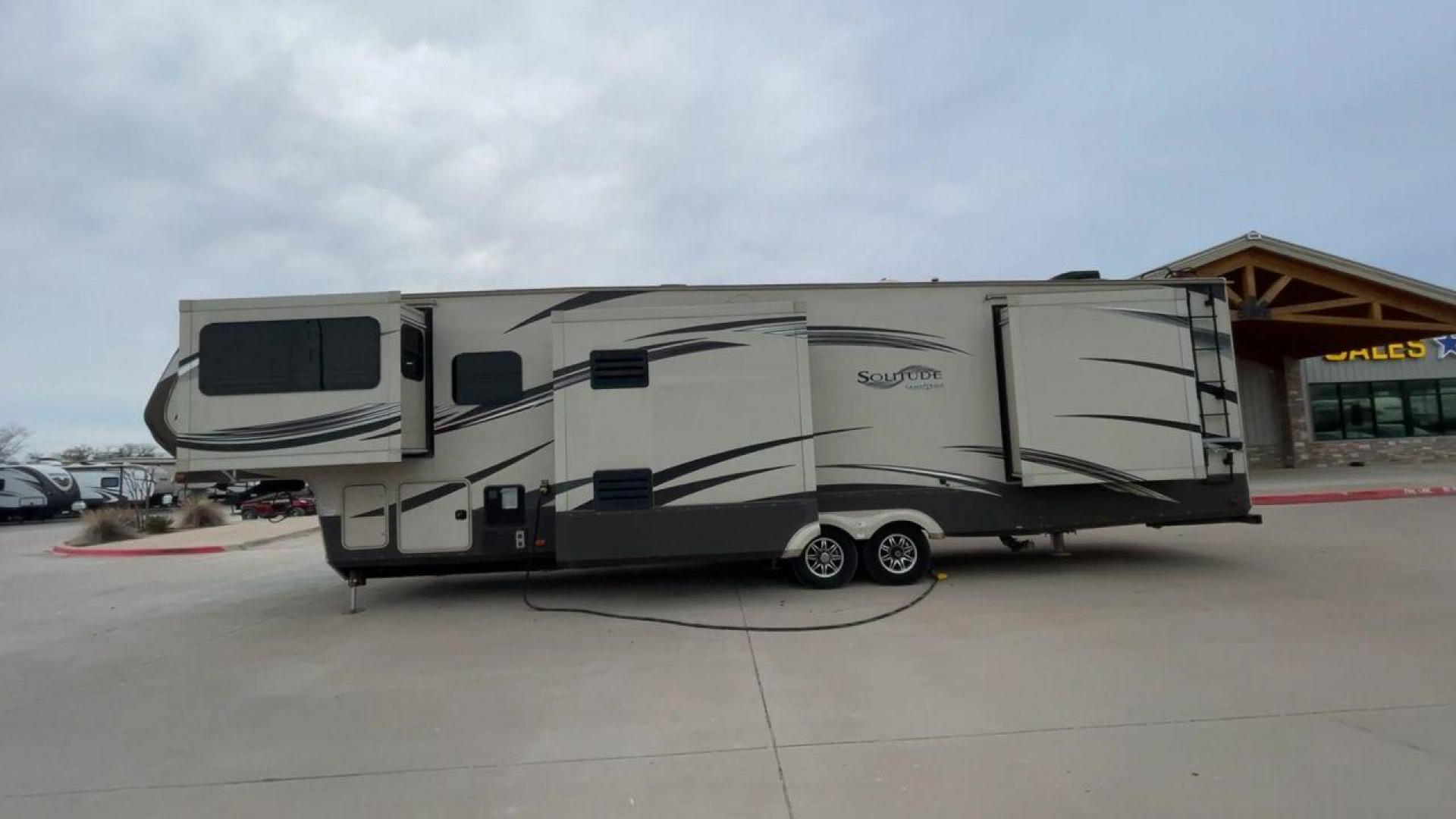 2015 BEIGE GRAND DESIGN SOLITUDE 379FL (573FS4325F1) , Length: 42.5 ft. | Dry Weight: 13,800 lbs. | Gross Weight: 16,000 lbs. | Slides: 5 transmission, located at 4319 N Main Street, Cleburne, TX, 76033, (817) 221-0660, 32.435829, -97.384178 - This 2015 GRSL Solitude 379 fifth wheel measures just over 42' in length. It is a dual axle and aluminum wheel setup with a GCWR of 16,000 lbs and a carrying capacity of 2,200 lbs. With five slides, this fifth wheel is spacious and comfortable! The Solitude's exterior is made from fiberglass, finish - Photo#6