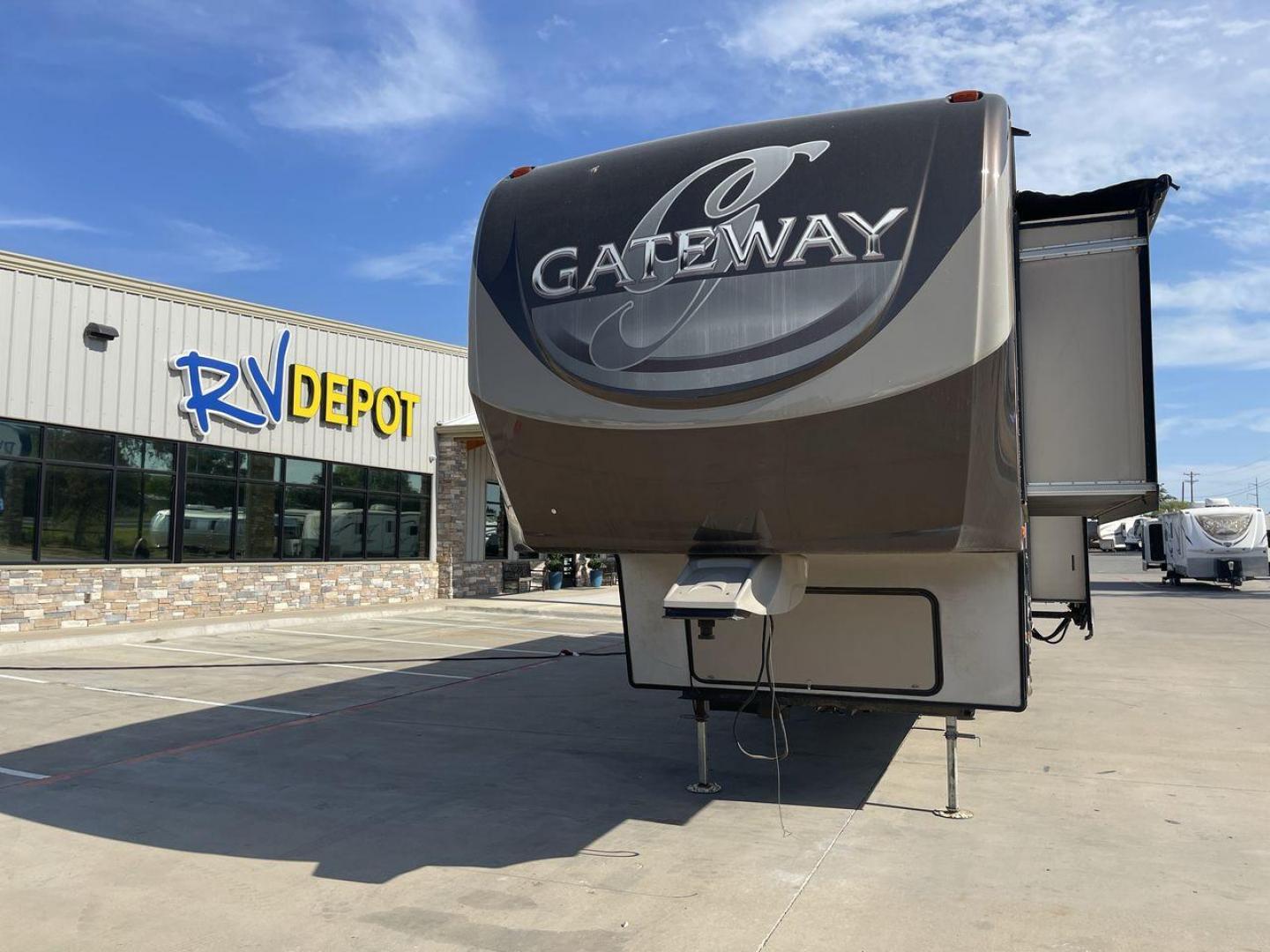 2015 BROWN HEARTLAND GATEWAY 3900SE (5SFSG4122FE) , Slides: 4 transmission, located at 4319 N Main Street, Cleburne, TX, 76033, (817) 221-0660, 32.435829, -97.384178 - The 2015 Heartland Gateway 3900SE is a luxurious and spacious fifth-wheel RV designed for comfort and extended camping adventures. Measuring 41 feet in length and 8 feet in width, this RV offers ample space and a striking exterior. Constructed with a strong and lightweight aluminum frame, and fiberg - Photo#0