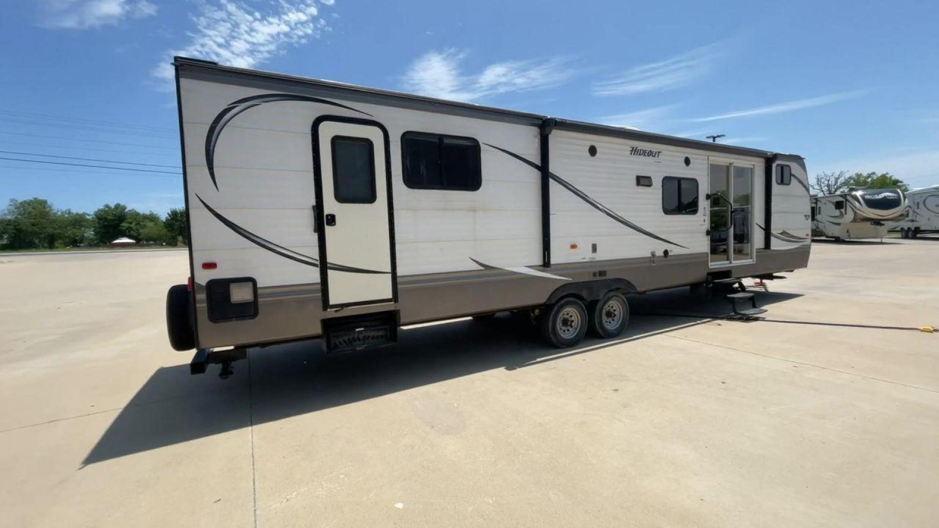 2015 KEYSTONE HIDEOUT 38BHDS (4YDT38B21F7) , Length: 39.83 ft. | Dry Weight: 8,420 lbs. | Gross Weight: 10,010 lbs. | Slides: 2 transmission, located at 4319 N Main Street, Cleburne, TX, 76033, (817) 221-0660, 32.435829, -97.384178 - Measuring 39.83 feet in length and boasting a dry weight of 8,420 lbs, the Hideout is both spacious and lightweight, making it easy to tow and maneuver. With a gross weight of 10,010 lbs, you'll have plenty of room for all your gear and supplies. With a wood body and aluminum sides, this trailer is - Photo#1