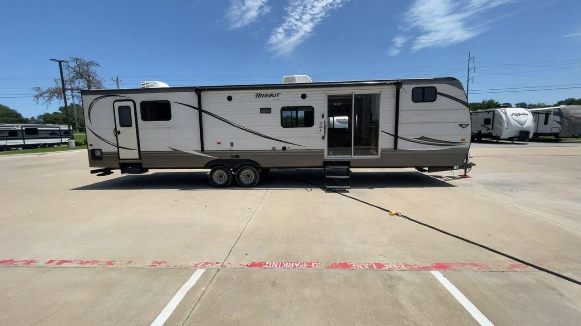 2015 KEYSTONE HIDEOUT 38BHDS (4YDT38B21F7) , Length: 39.83 ft. | Dry Weight: 8,420 lbs. | Gross Weight: 10,010 lbs. | Slides: 2 transmission, located at 4319 N Main Street, Cleburne, TX, 76033, (817) 221-0660, 32.435829, -97.384178 - Measuring 39.83 feet in length and boasting a dry weight of 8,420 lbs, the Hideout is both spacious and lightweight, making it easy to tow and maneuver. With a gross weight of 10,010 lbs, you'll have plenty of room for all your gear and supplies. With a wood body and aluminum sides, this trailer is - Photo#2