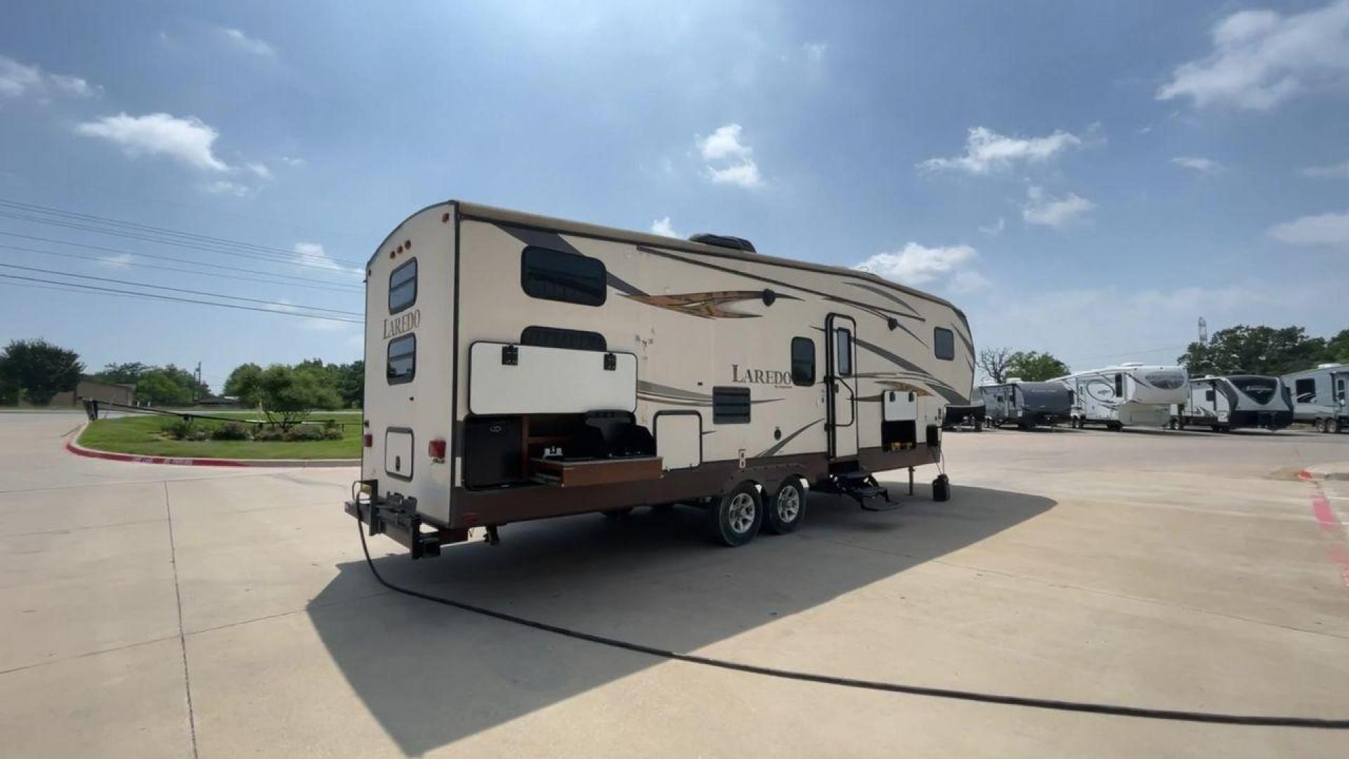 2015 WHITE KEYSTONE LAREDO 285SBH (4YDF28522FK) , Length: 33 ft. | Dry Weight: 7,880 lbs. | Gross Weight: 9,580 lbs. | Slides: 1 transmission, located at 4319 N Main Street, Cleburne, TX, 76033, (817) 221-0660, 32.435829, -97.384178 - This 2015 Keystone Fifth Wheel measures 33 feet long and 8 feet wide with a dry weight of 7,880 lbs. It has a GVWR of 9,580 lbs and a hitch weight of 1,465 lbs. This model also comes with automatic heating and cooling rated at 30,000 and 13,500 BTUs respectively. The exterior of this unit is a base - Photo#2