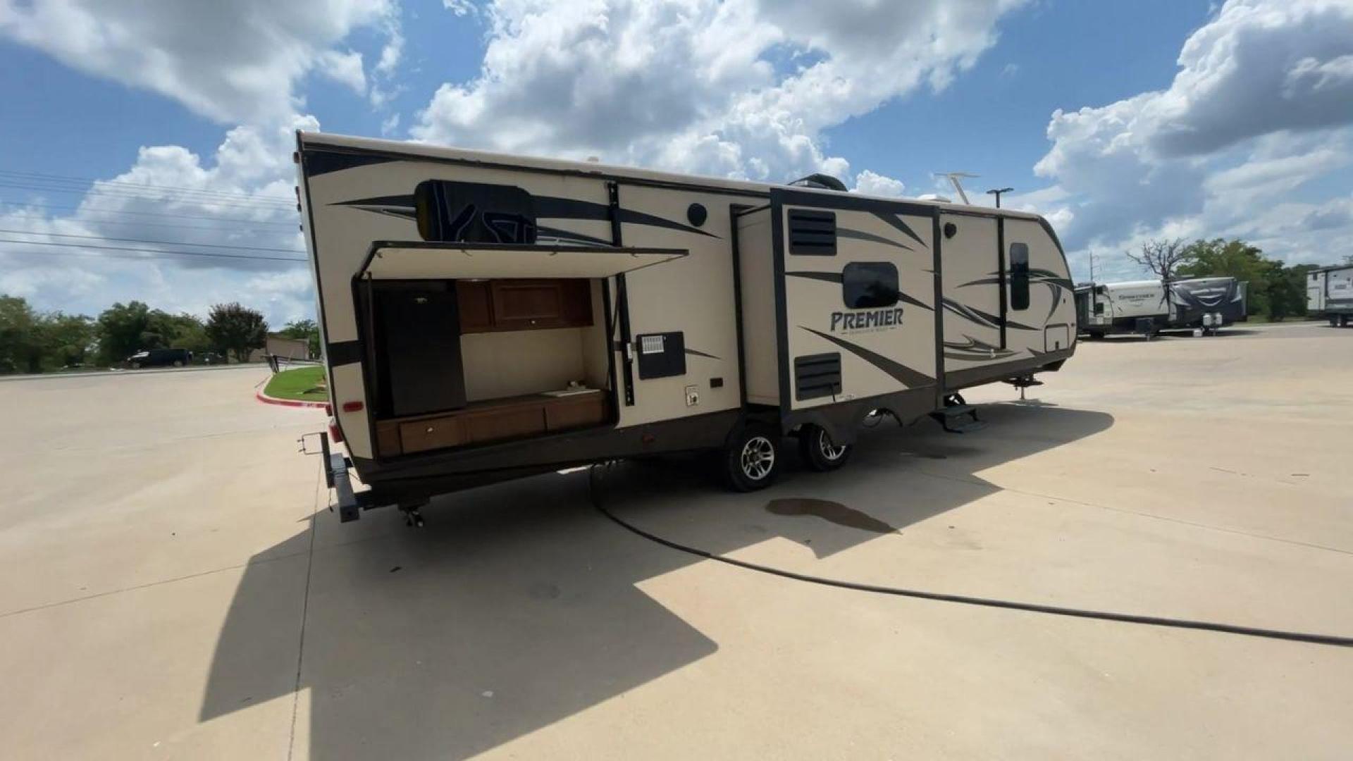 2015 TAN KEYSTONE PREMIER 34BHPR (4YDT34B25FD) , Length: 37 ft. | Dry Weight: 7,076 lbs. | Gross Weight: 8,800 lbs. | Slides: 3 transmission, located at 4319 N Main Street, Cleburne, TX, 76033, (817) 221-0660, 32.435829, -97.384178 - Take a trip with more family members and friends in this remarkably spacious 2015 Keystone Premier 34BHPR! This travel trailer measures exactly 37 ft. in length and 10.92 ft. in height. It has a dry weight of 7,076 lbs. and a GVWR of 8,800 lbs. It highlights a rear bunk and an outside kitchen, ma - Photo#1