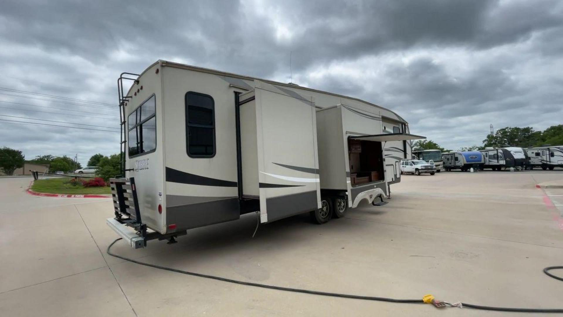 2015 TAN PALOMINO SABRE 34RDKS (4X4FSRK2XF3) , Length: 38.92 ft. | Dry Weight: 11,081 lbs. | Gross Weight: 13,950 lbs. | Slides: 4 transmission, located at 4319 N Main Street, Cleburne, TX, 76033, (817) 221-0660, 32.435829, -97.384178 - This 2015 Sabre Fifth Wheel measures at just under 39 feet with a dry weight of 11,081 lbs. It has a GVWR of 13,950 lbs and a hitch weight of 2,205 lbs. This unit has a heater rated at 35,000 BTUs and a cooler rated at 13,500 BTUs meaning the temperature is always in your control. This model has a b - Photo#1