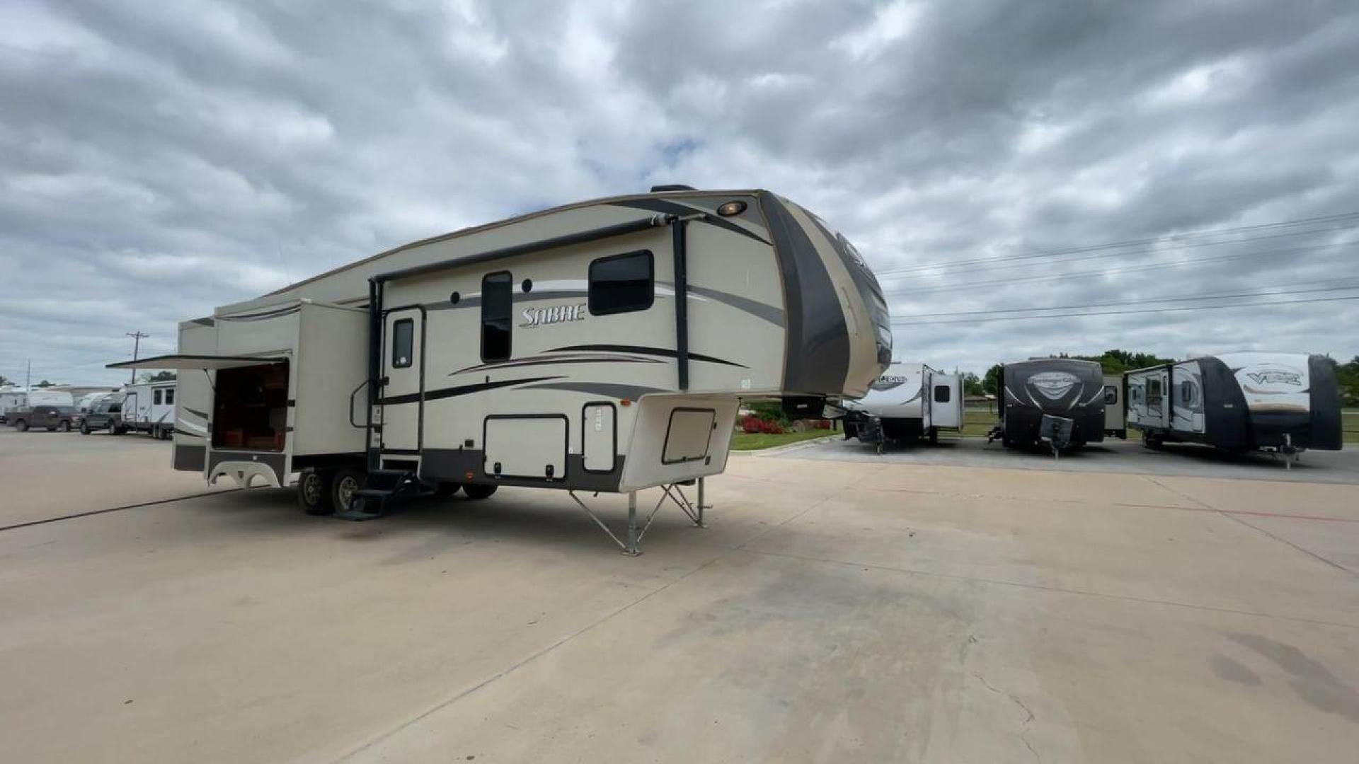 2015 TAN PALOMINO SABRE 34RDKS (4X4FSRK2XF3) , Length: 38.92 ft. | Dry Weight: 11,081 lbs. | Gross Weight: 13,950 lbs. | Slides: 4 transmission, located at 4319 N Main Street, Cleburne, TX, 76033, (817) 221-0660, 32.435829, -97.384178 - This 2015 Sabre Fifth Wheel measures at just under 39 feet with a dry weight of 11,081 lbs. It has a GVWR of 13,950 lbs and a hitch weight of 2,205 lbs. This unit has a heater rated at 35,000 BTUs and a cooler rated at 13,500 BTUs meaning the temperature is always in your control. This model has a b - Photo#3