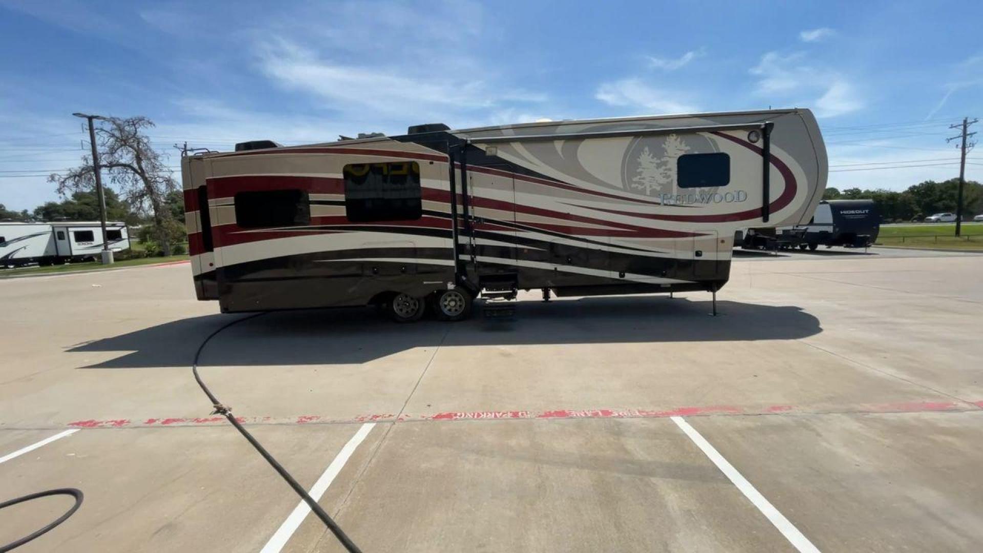 2015 REDWOOD 38RL (4V0FC3823FR) , Length: 41.42 ft. | Dry Weight: 13,672 lbs. | Gross Weight: 16,500 lbs. | Slides: 3 transmission, located at 4319 N Main Street, Cleburne, TX, 76033, (817) 221-0660, 32.435829, -97.384178 - The 2015 Redwood 38RL is a stunning fifth wheel that offers luxury, comfort, and spacious living. With an overall length of 41.42 feet and a dry weight of 13,672 lbs, this unit is built for those seeking an upscale RVing experience. The exterior features a sleek and modern design with bold maroon an - Photo#2