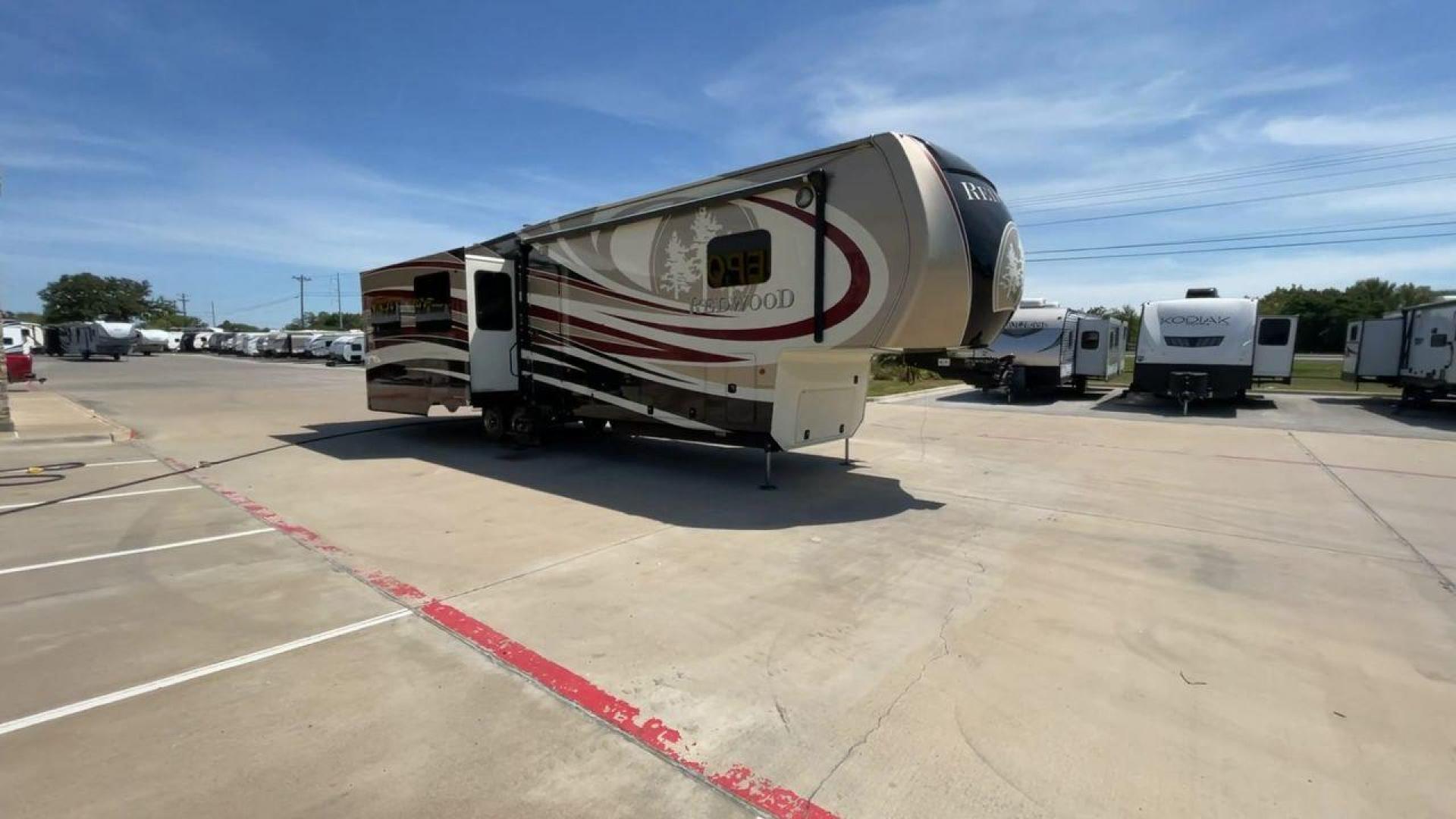 2015 REDWOOD 38RL (4V0FC3823FR) , Length: 41.42 ft. | Dry Weight: 13,672 lbs. | Gross Weight: 16,500 lbs. | Slides: 3 transmission, located at 4319 N Main Street, Cleburne, TX, 76033, (817) 221-0660, 32.435829, -97.384178 - The 2015 Redwood 38RL is a stunning fifth wheel that offers luxury, comfort, and spacious living. With an overall length of 41.42 feet and a dry weight of 13,672 lbs, this unit is built for those seeking an upscale RVing experience. The exterior features a sleek and modern design with bold maroon an - Photo#3